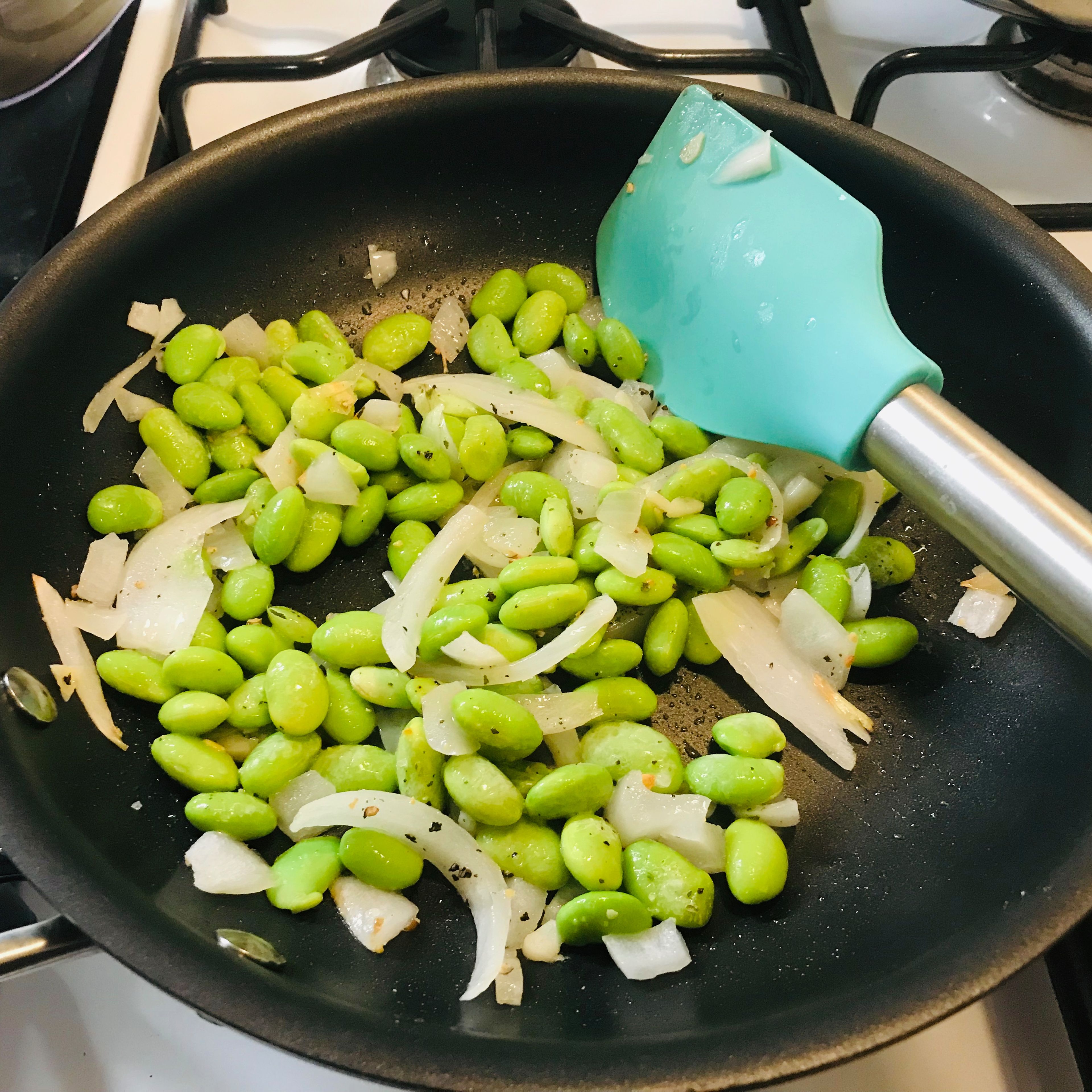 Cook the “beans”: In the same nonstick pan (no need to wash), turn heat to medium and add canola or vegetable oil. Sauté the onion and edamame for 3-5 minutes. Season with salt and ground pepper.