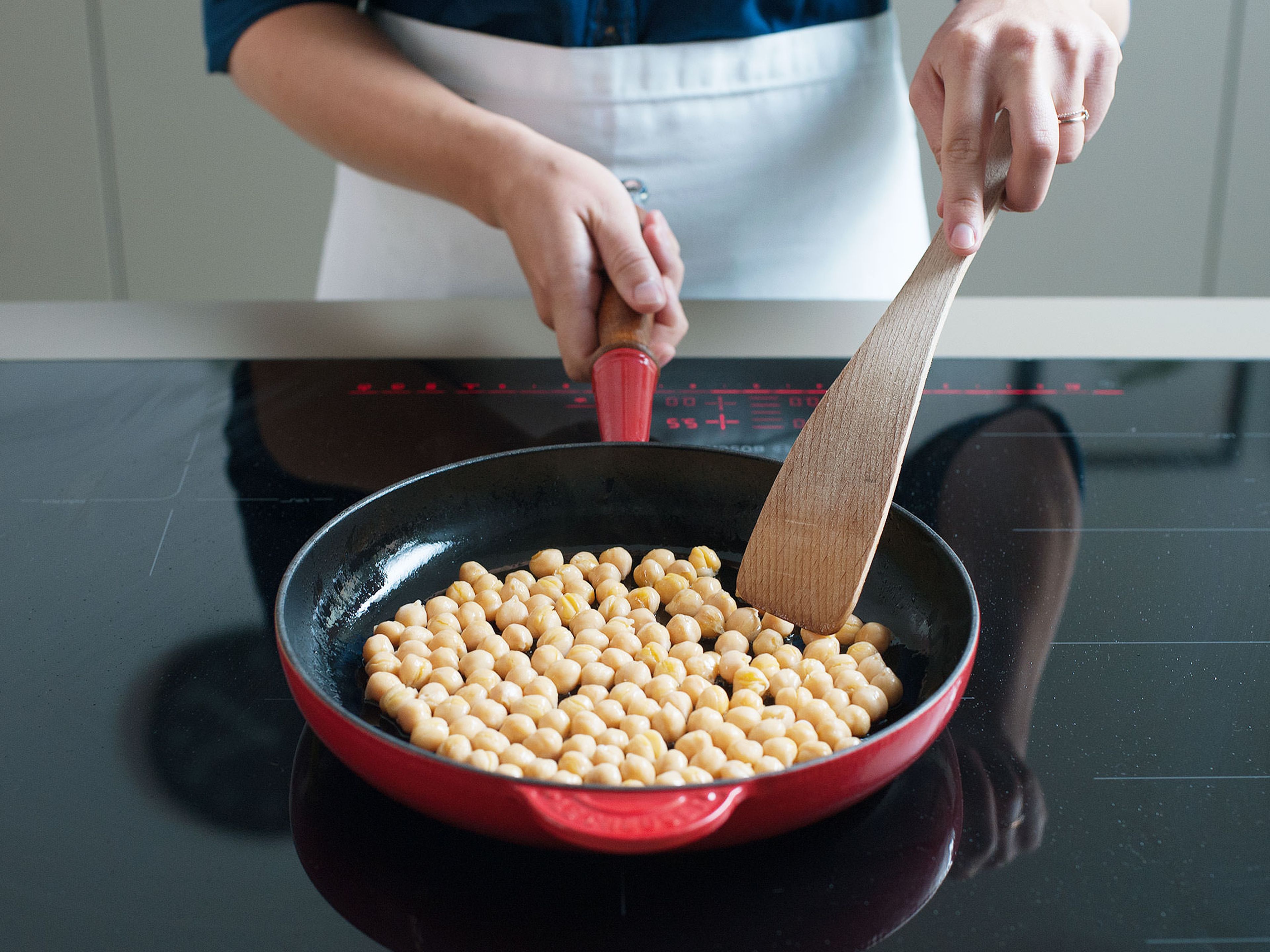 Heat some olive oil in a large skillet over medium-high heat. Add drained chickpeas and fry until golden and crisp, approx. 15 min. Transfer to a paper towel-lined plate to drain.