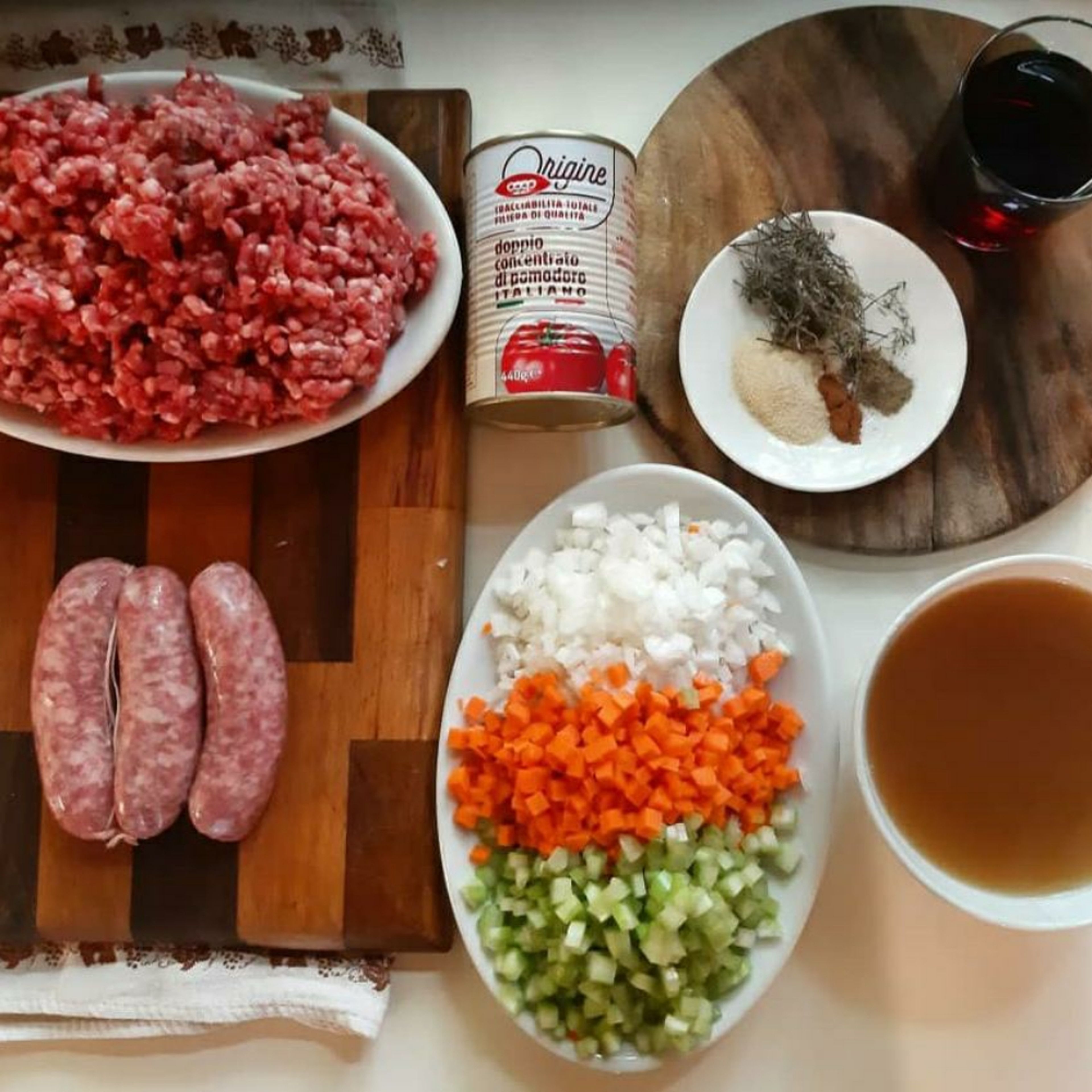 Prepare all the ingredients. Dice the vegetables, grate the garlic, prepare the spice mix, take the sausage mince out of the external membrane and chop it up.