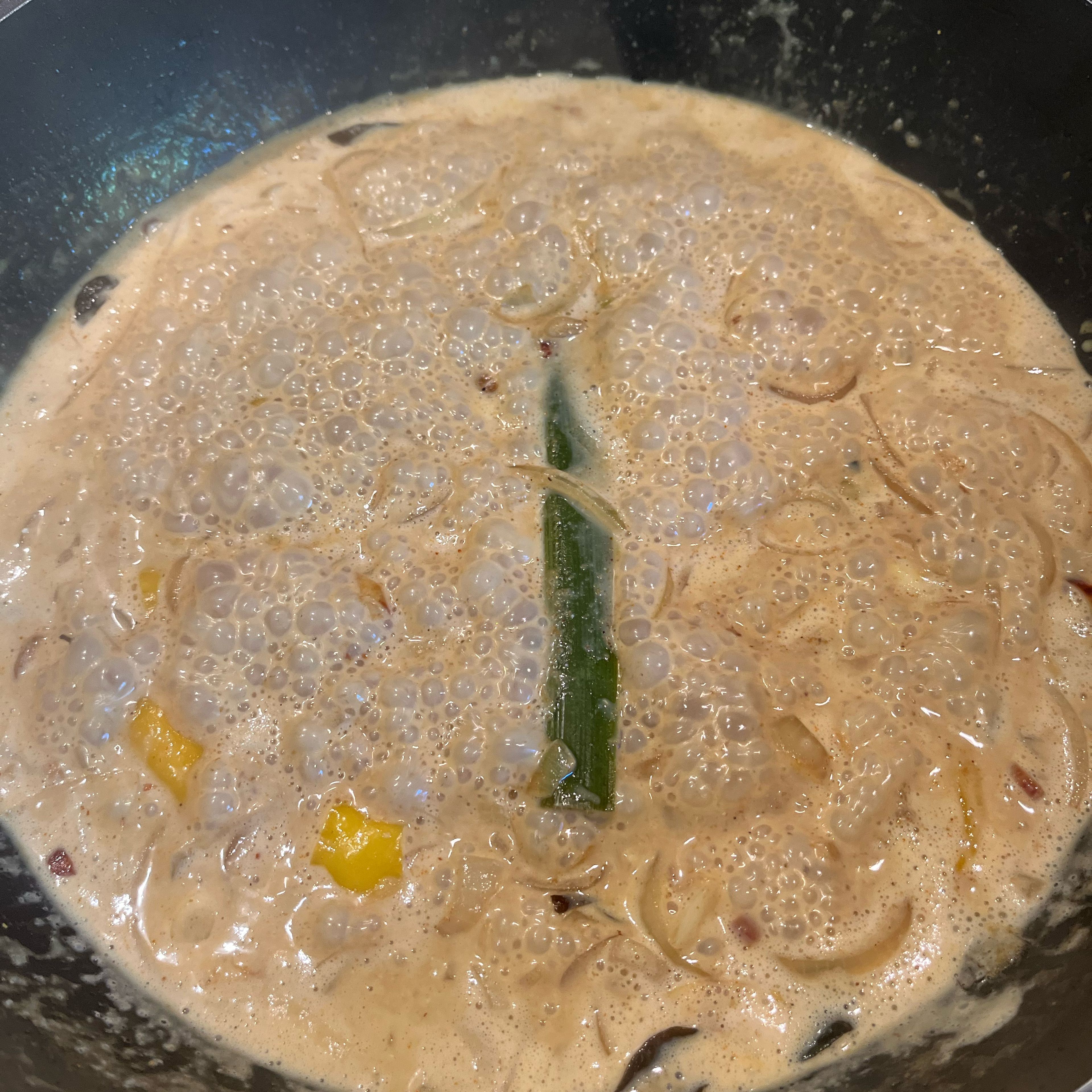 Fry onion with curry leaves and pandan leaf 1-2 min. Add ginger, garlic, chili pepper, cayenne pepper and curry powder. Stir fry for 2-3 min. At last add tamarind paste and coconut milk, and simmer gravy until thick.