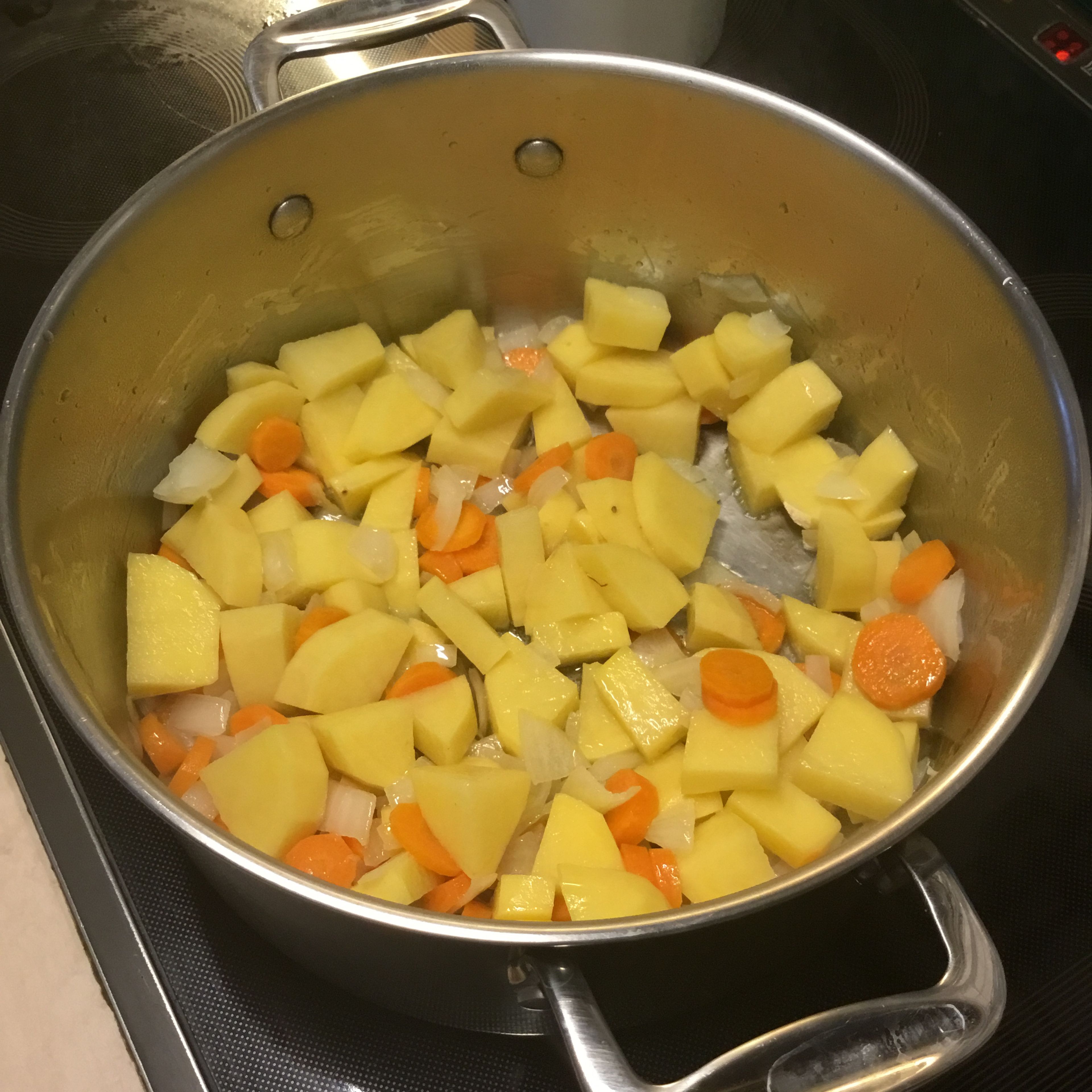 Dann die Kartoffeln dazufügen und ein paar Minuten zugedeckt weiterdünsten.