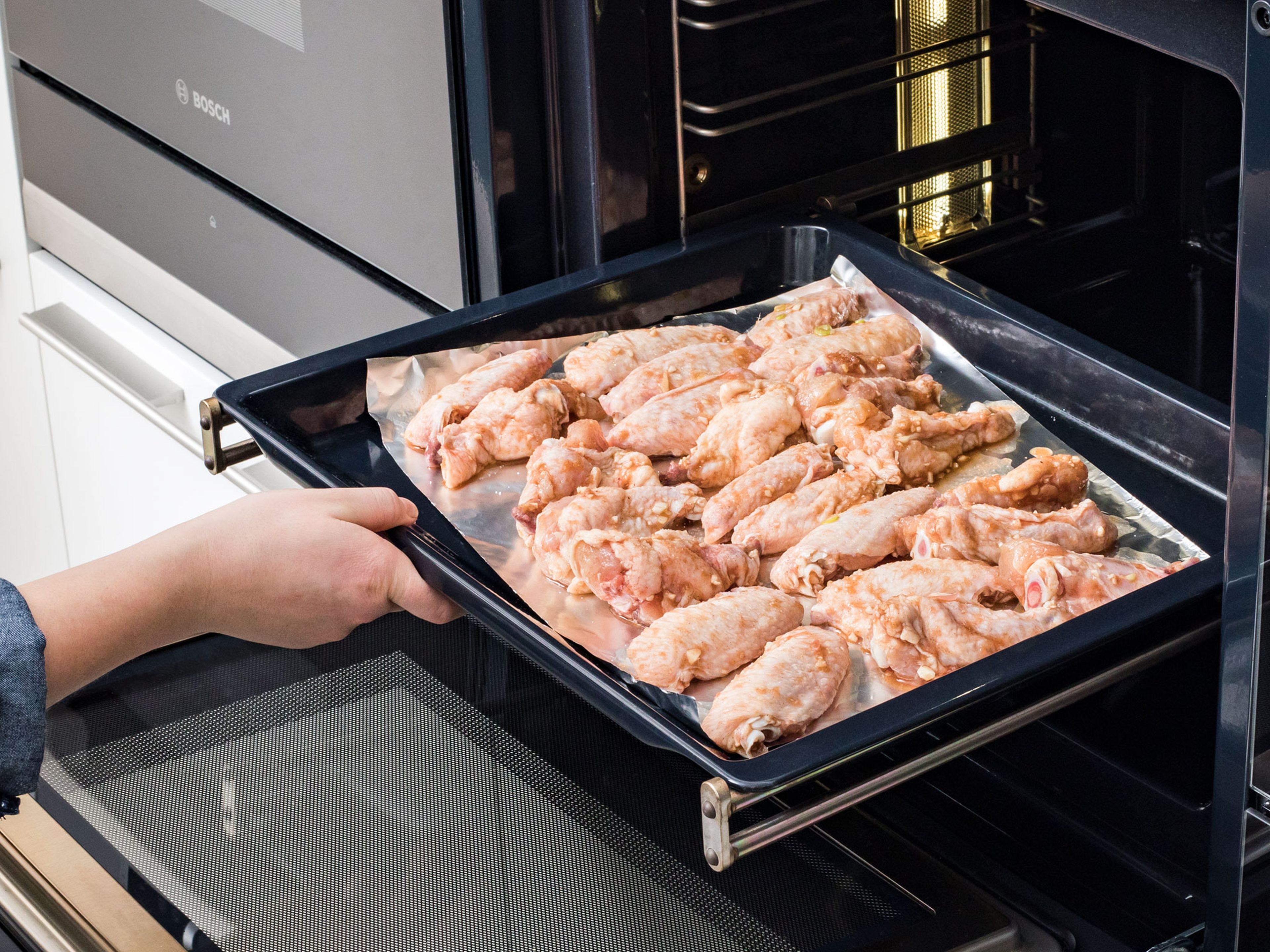 Preheat oven to 220°C/425°F, take out the chicken wings and pat them dry, then season with salt. Place on a baking sheet lined with aluminum foil. Bake for approx. 30 – 40 min.