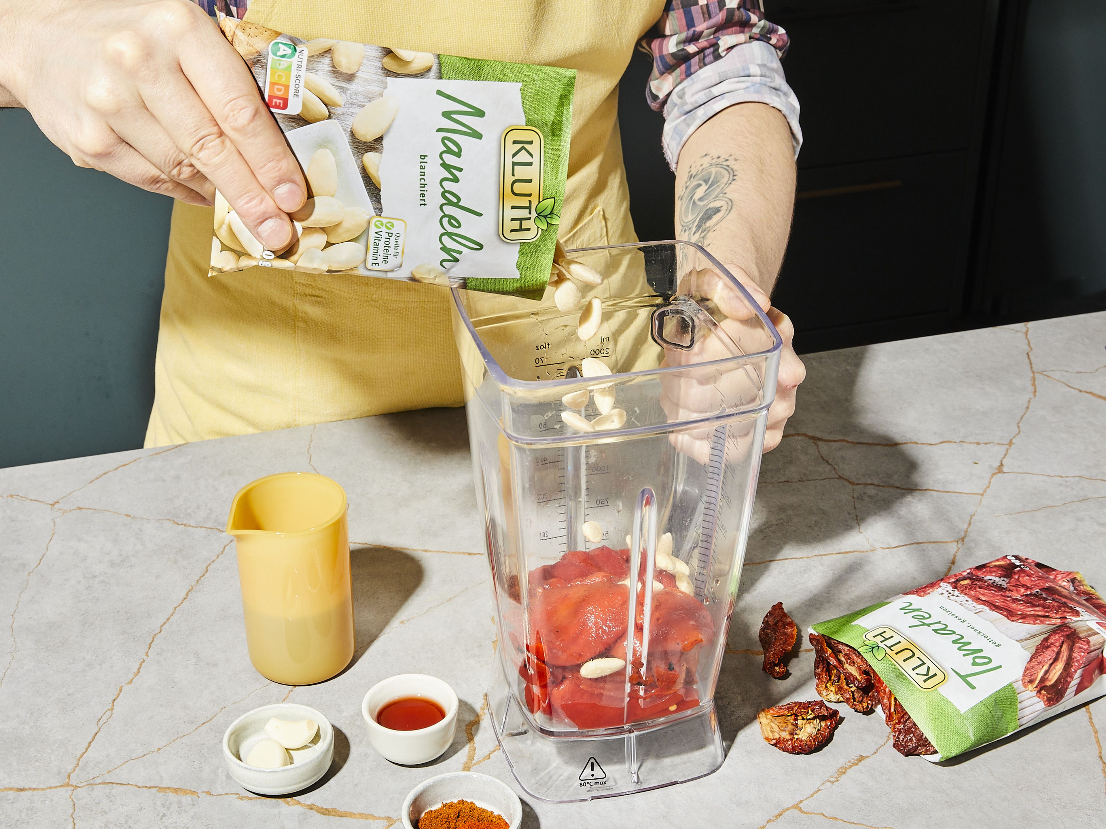 Den Knoblauch schälen und in einem Mixer oder einer Küchenmaschine zusammen mit gegrillter Paprika, Mandeln, getrockneten Tomaten, Rotweinessig, Paprikapulver und Cayennepfeffer vermengen.