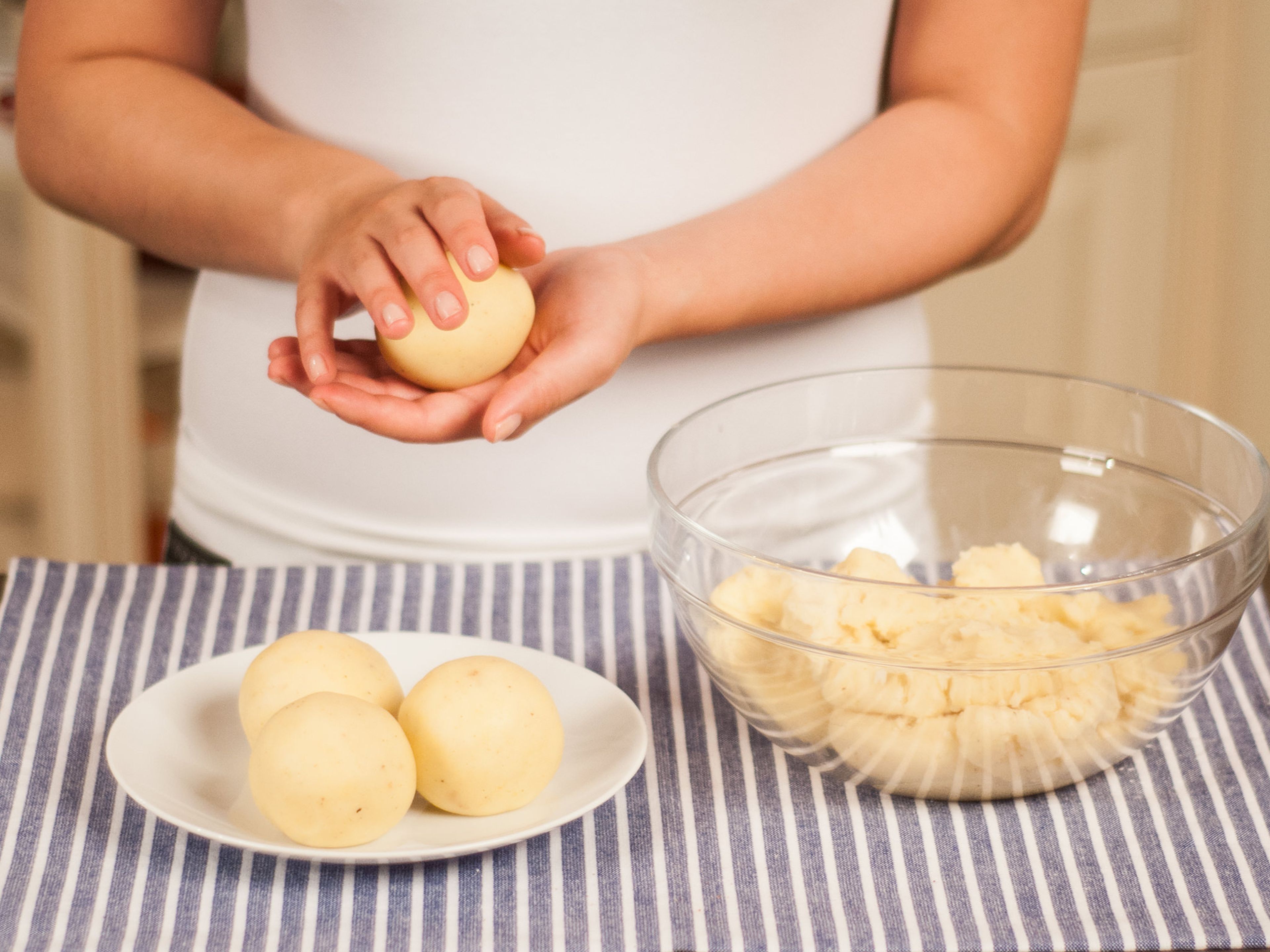 Take a handful of the dough (approx. 3 tablespoons each) and form into small balls by rolling each dough ball between your palms. Set aside.
