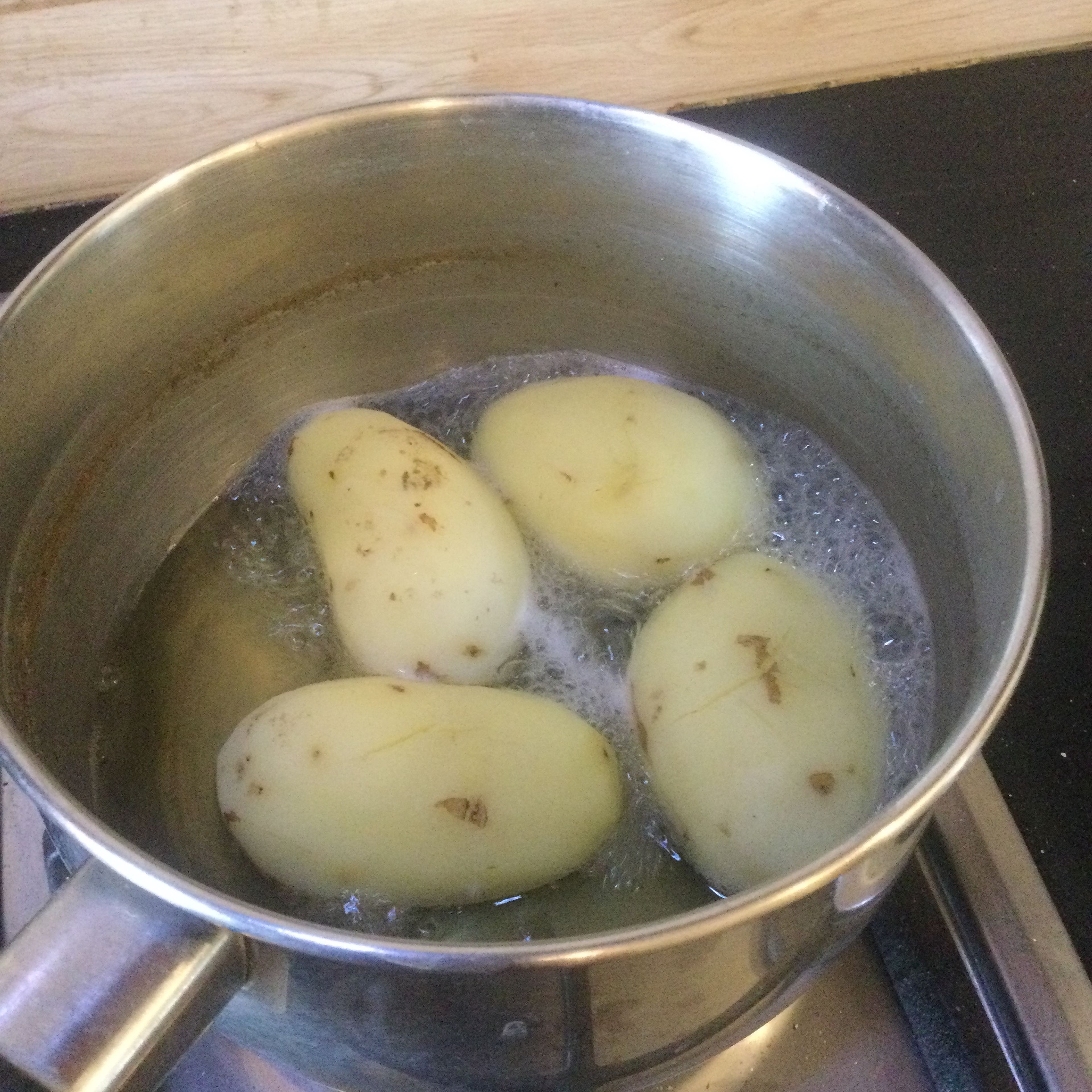 Peel and boil the potatoes in salted water
