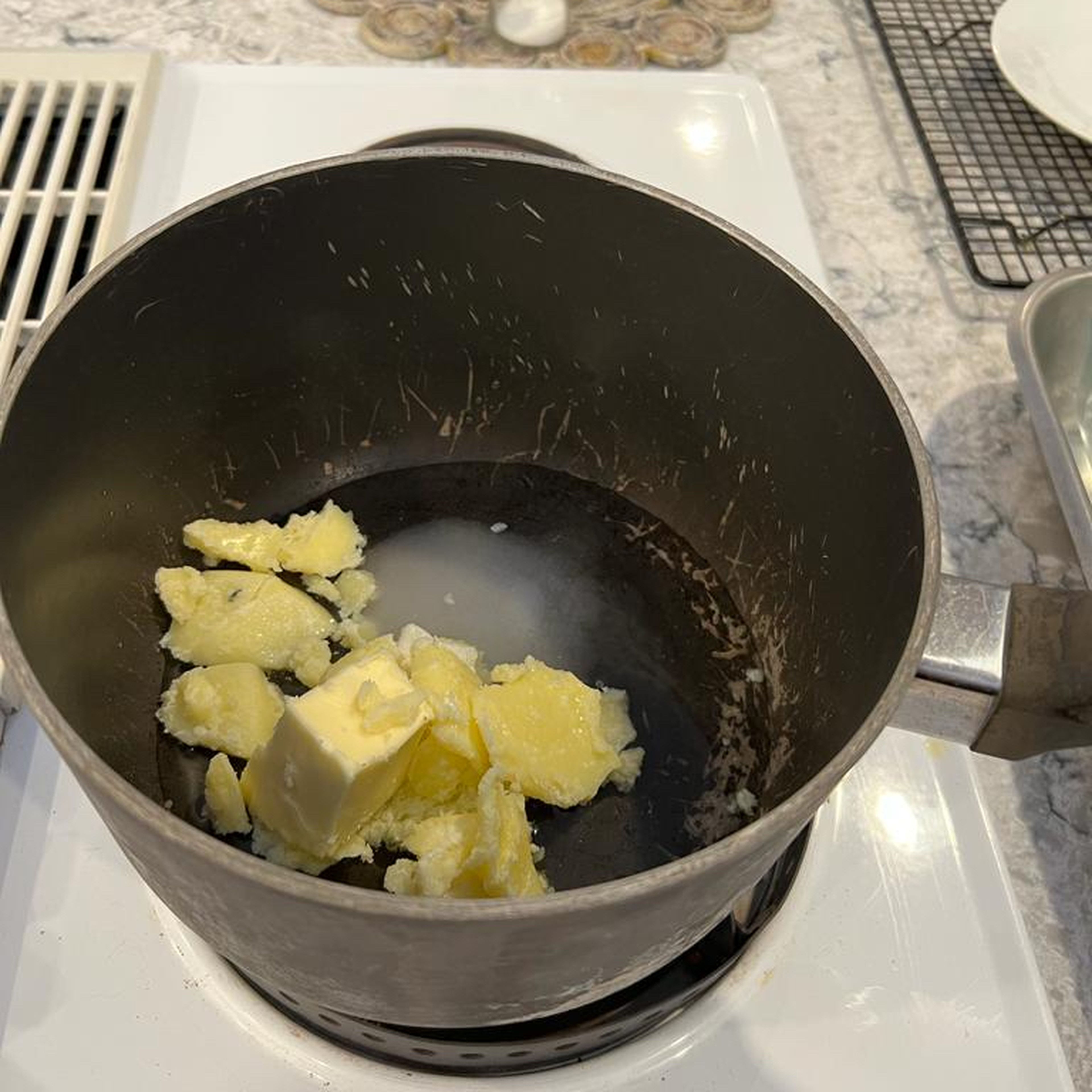 Melt butter, water, sugar, and salt in a saucepan until the water just starts to boil/bubble