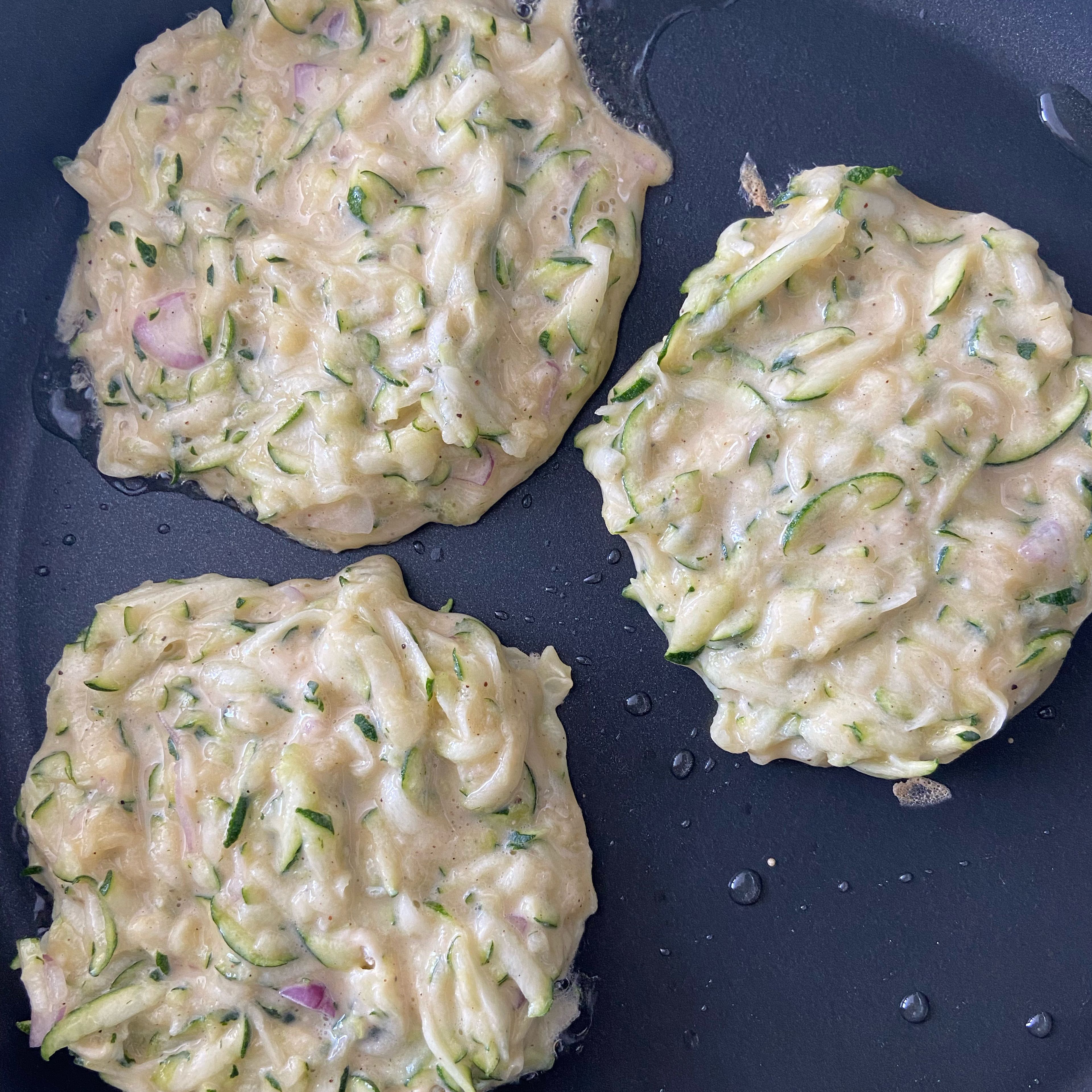 Use a tbsp to scoop zucchini mixture to the pan.