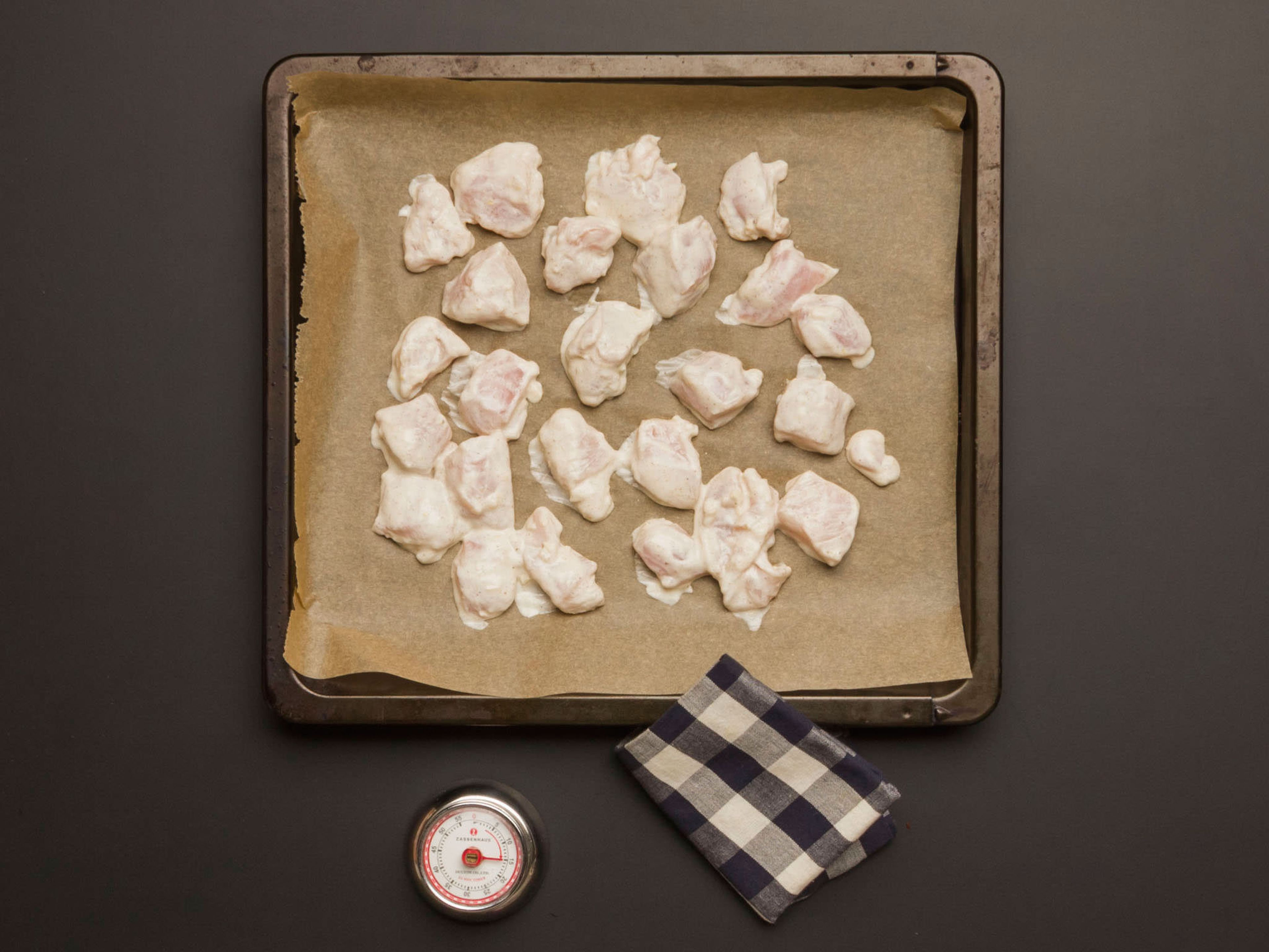 Mariniertes Hähnchen auf ein mit Backpapier ausgelegtes Backblech geben und im vorgeheizten Ofen ca. 15 Min. bei 180°C goldbraun backen.