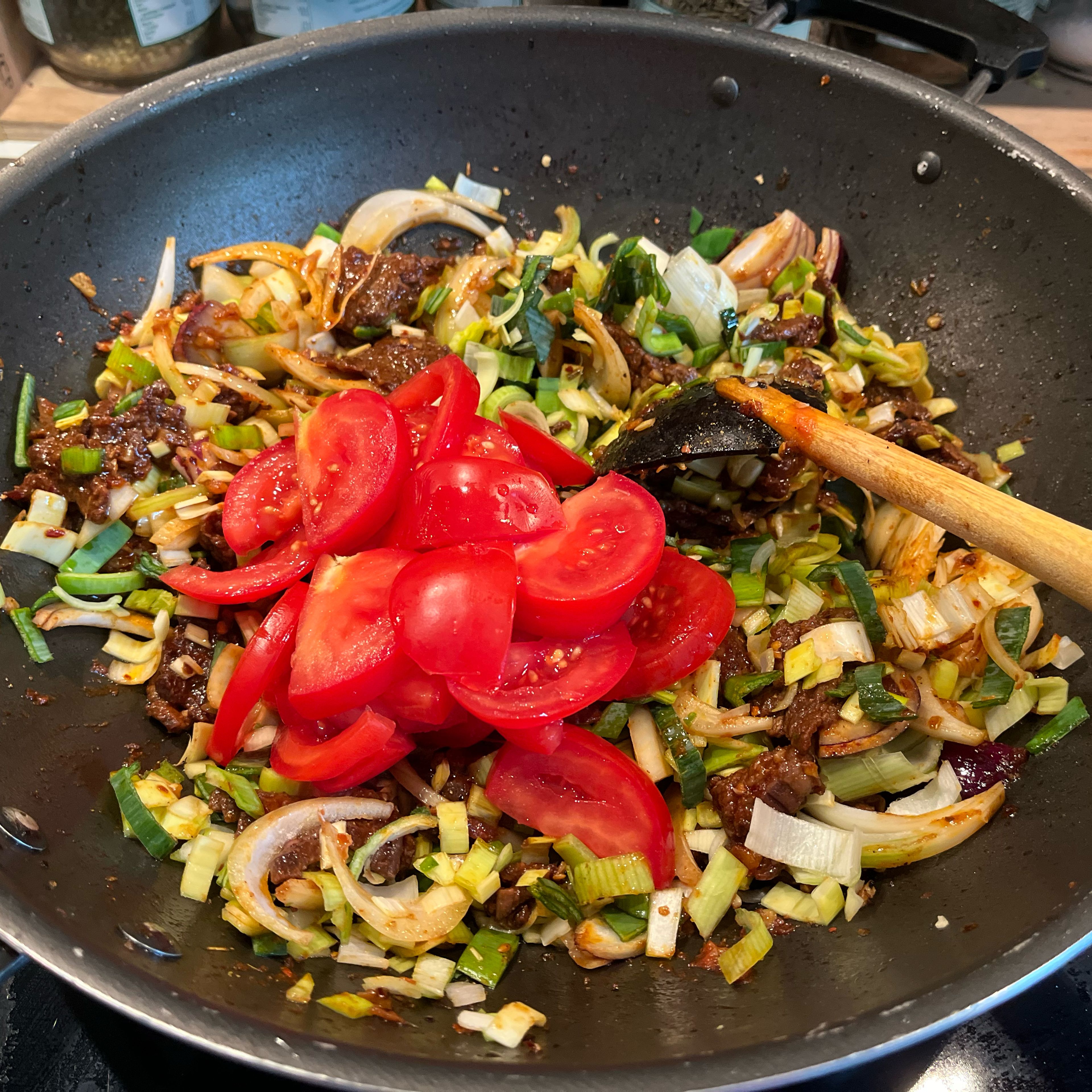 Add tomato sauce, soy sauce, sugar, onion, leeks and tomatoes. Keep stirring until veggies are cooked. Taste and add remaining salt to taste and mix. Remove from heat and serve with rice.