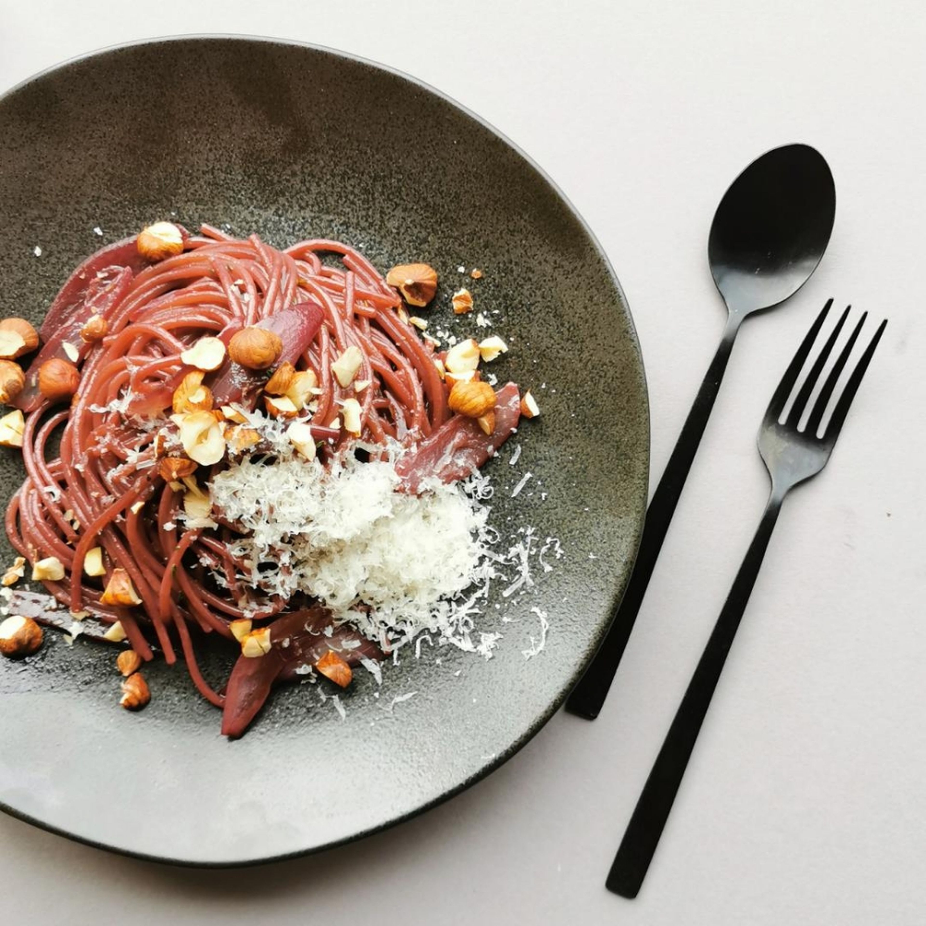 Assemble the pasta on a plate and serve with freshly grated Parmesan cheese and hazelnuts. Bon appétit!