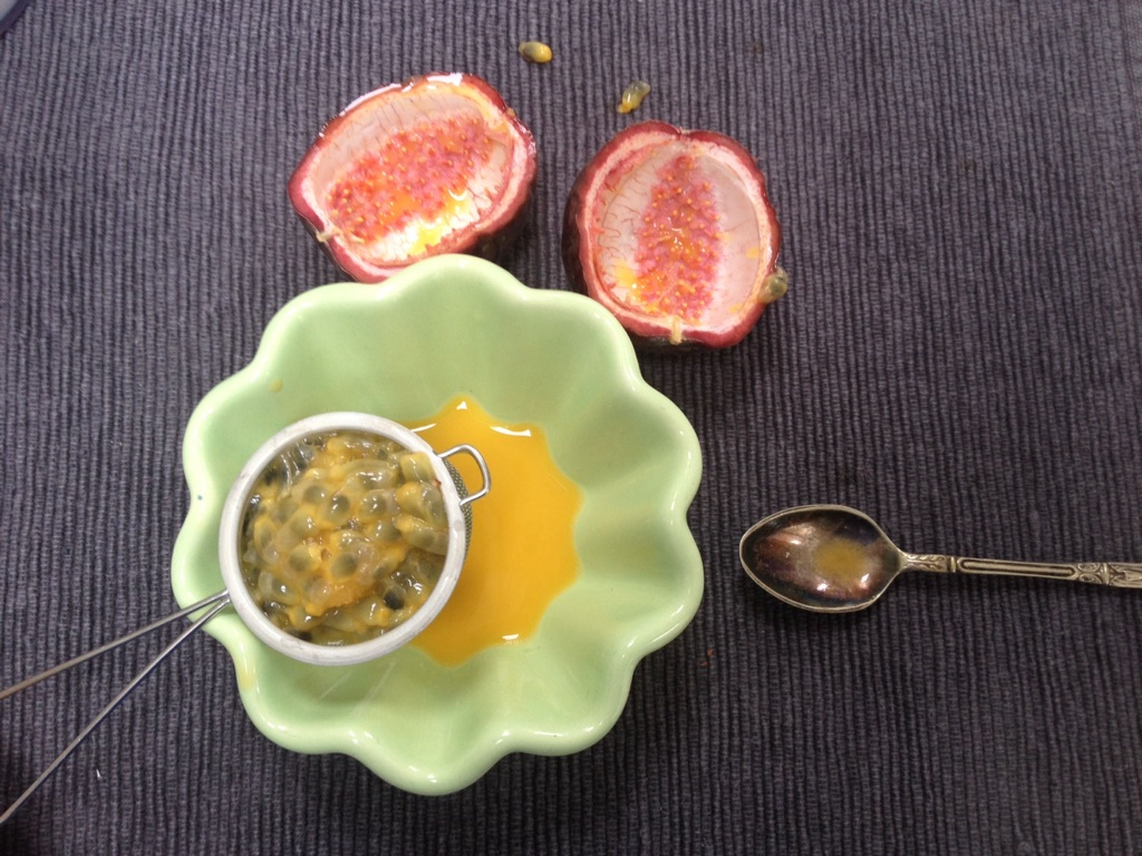 Halve the passion fruit and scoop the seeds into a fine sieve. Strain.