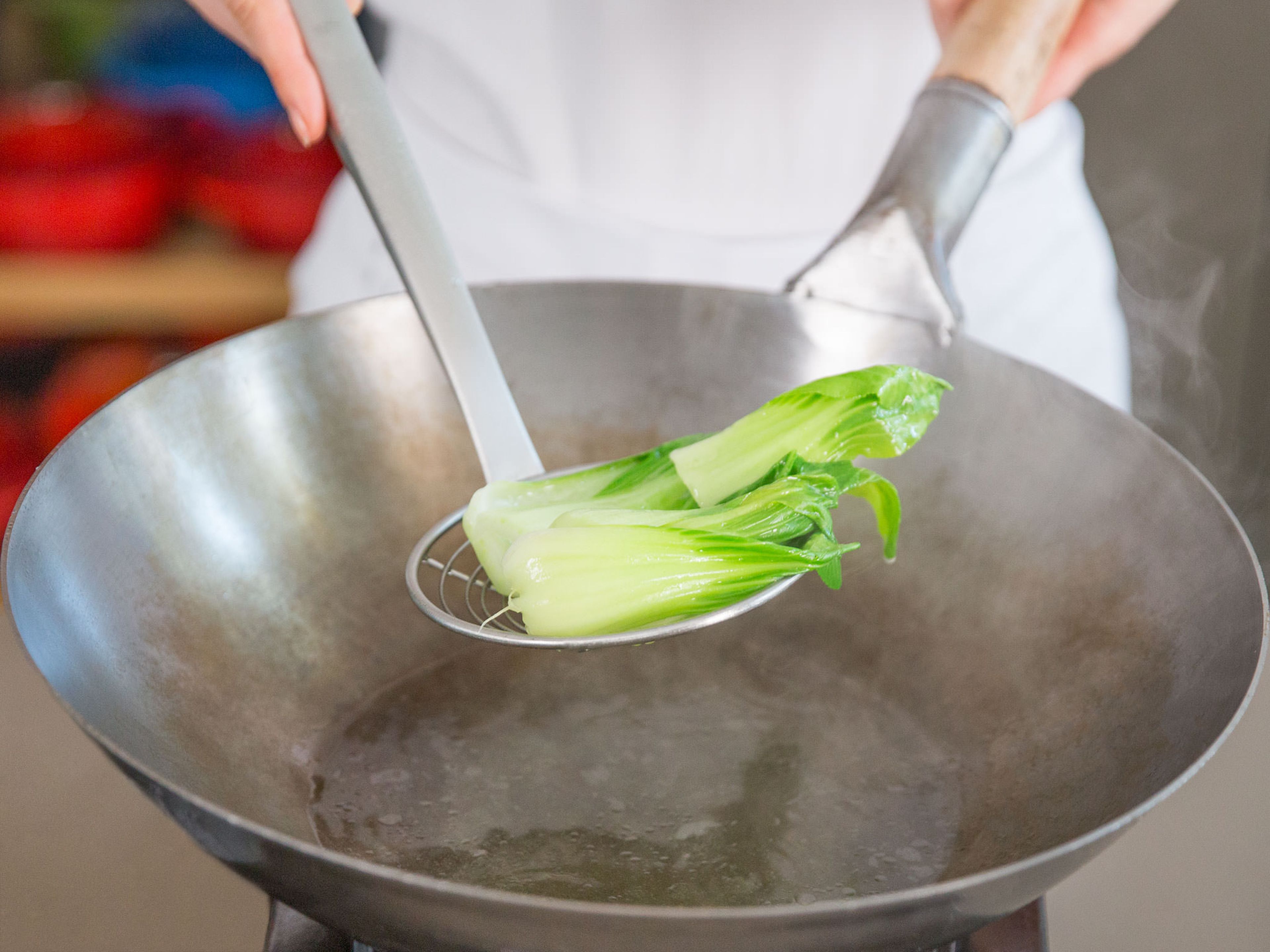 Remove bok choy from wok and set aside.