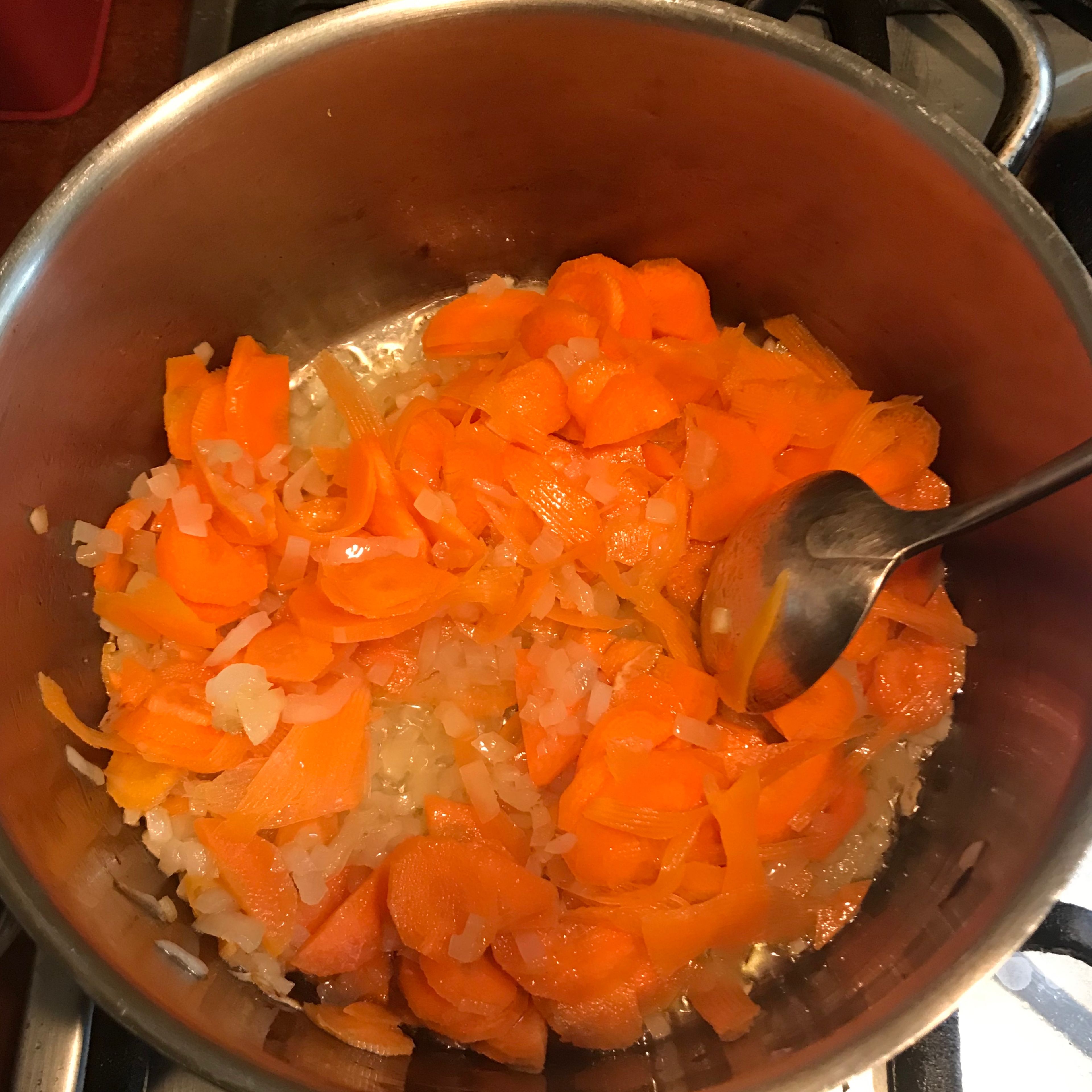 Heat the olive oil to the carrots and the onion until they are soft