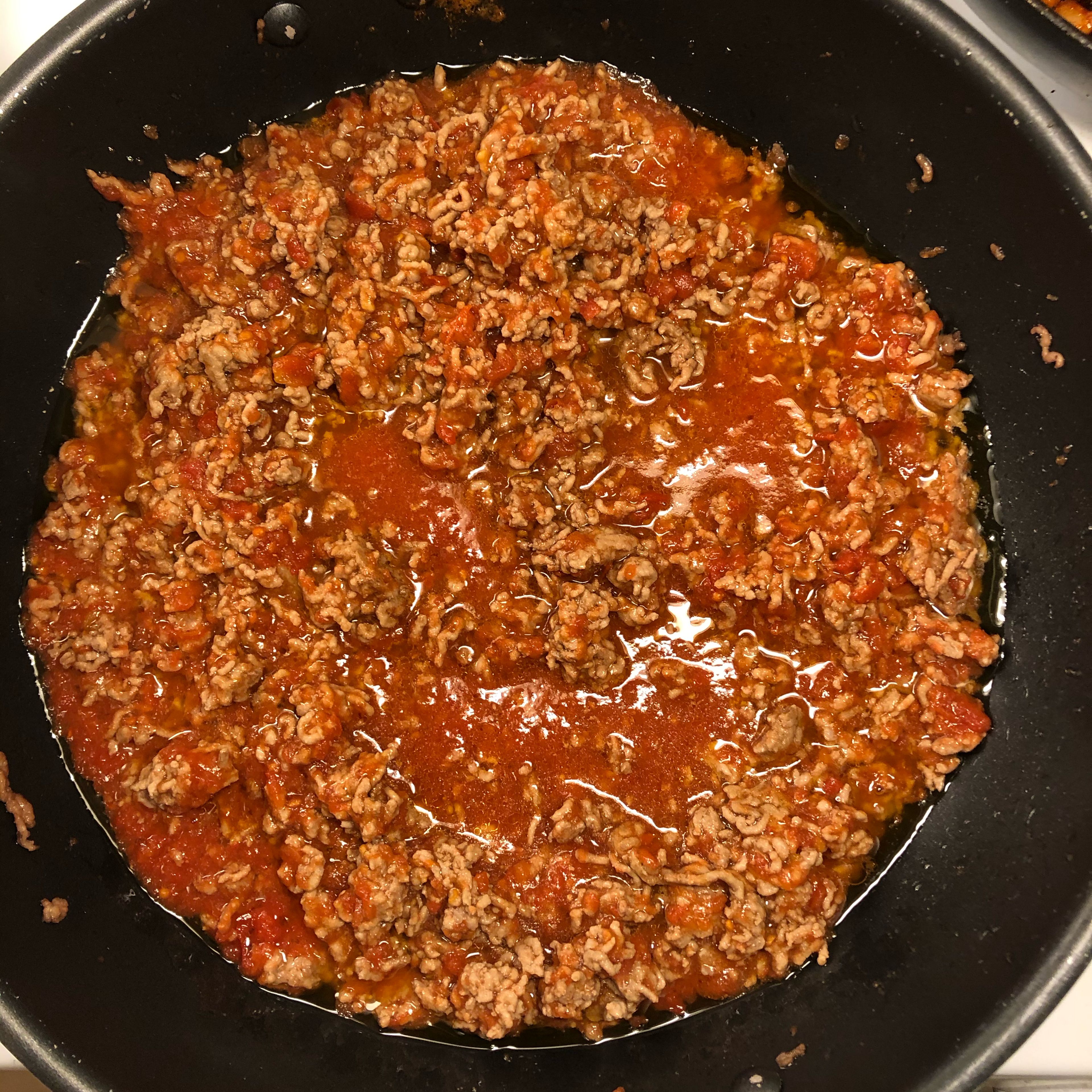 Fry the minced meat in butter on low temperature, add tomatoe sauce and let simmer.