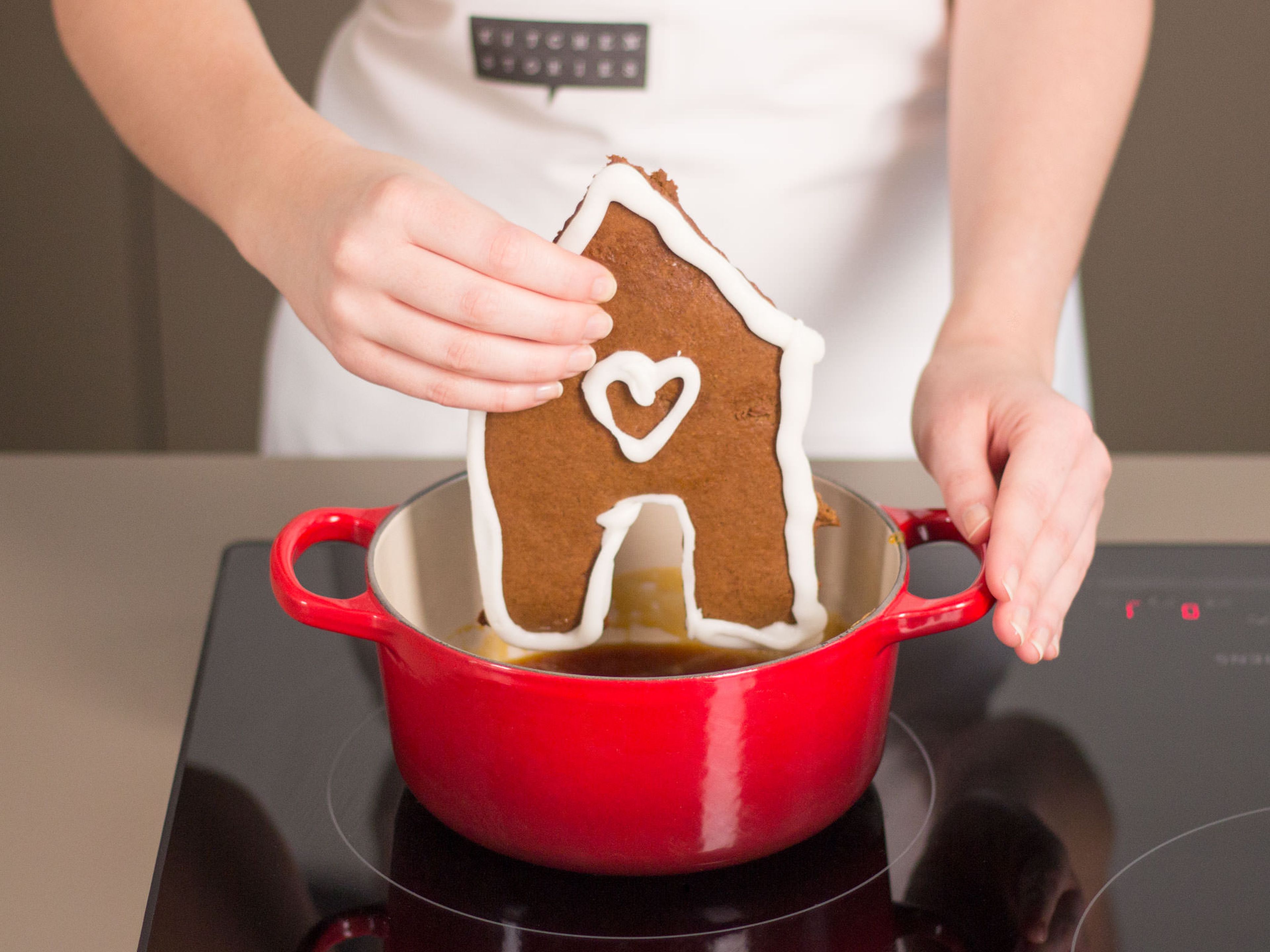 Melt sugar and a little water in a small saucepan and cook over medium heat until a dark caramel forms. Carefully dip bottom of house pieces in caramel and stick to a serving plate. Use caramel to stick together other inner edges and to attach Christmas trees and gingerbread men.