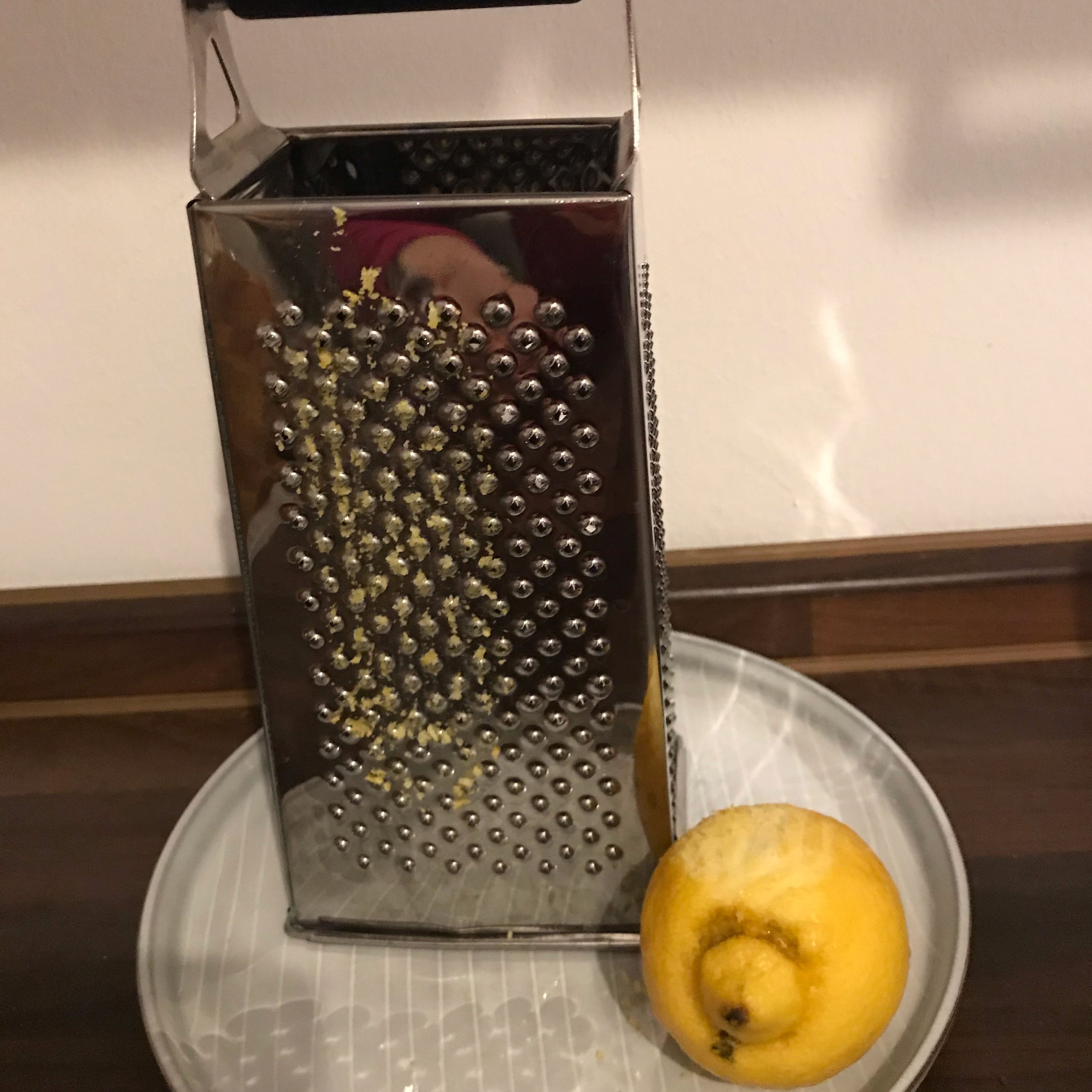 Die Zitrone lauwarm abwaschen￼Die Schale der Zitrone abreiben￼.In einen kleinen Topf geben