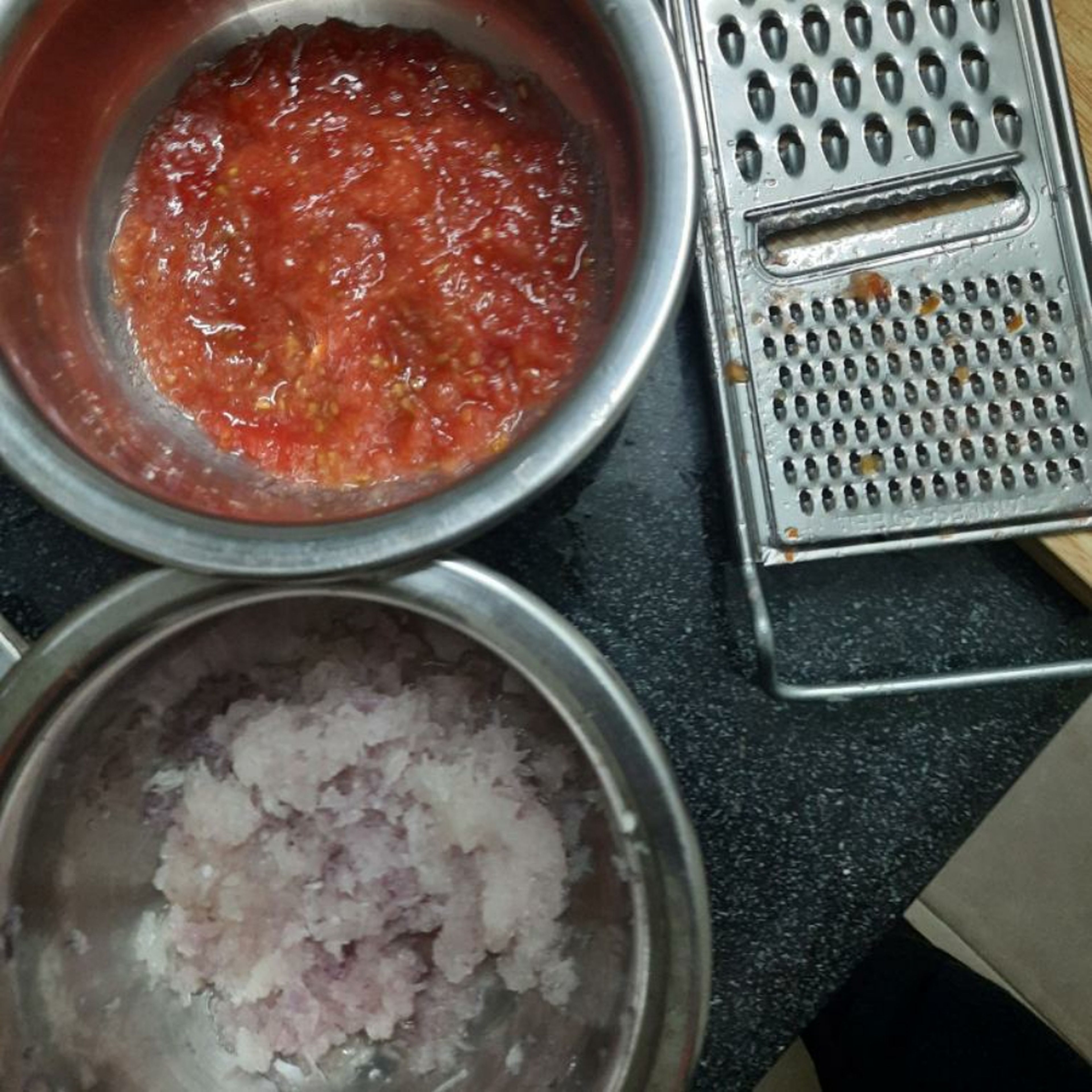 Make puree/paste from onion and tomato. If you don't have a grinder, you can simply grate the onion/tomato to get its puree.