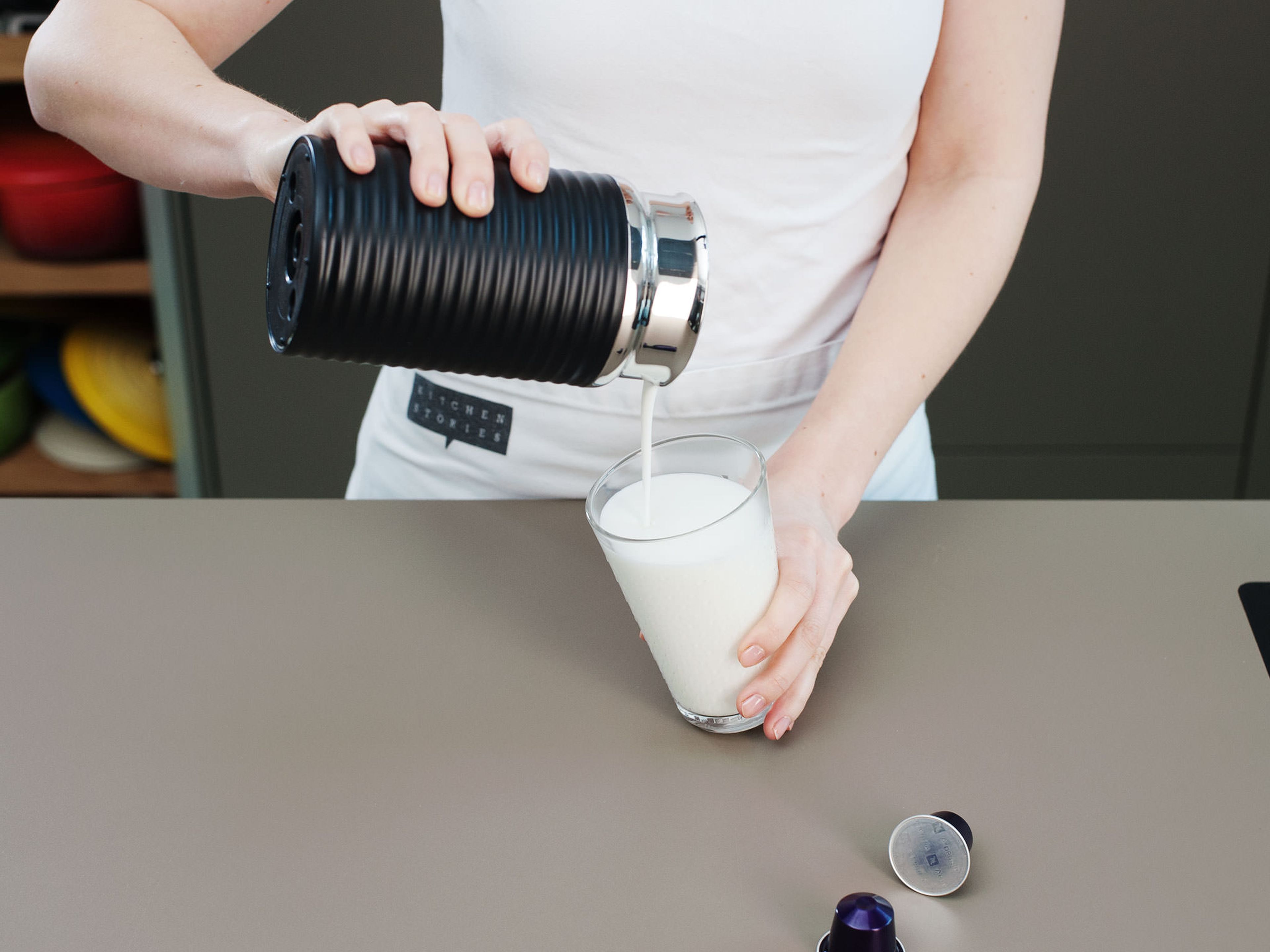 Using your Nespresso milk frother, froth milk and pour in glass.