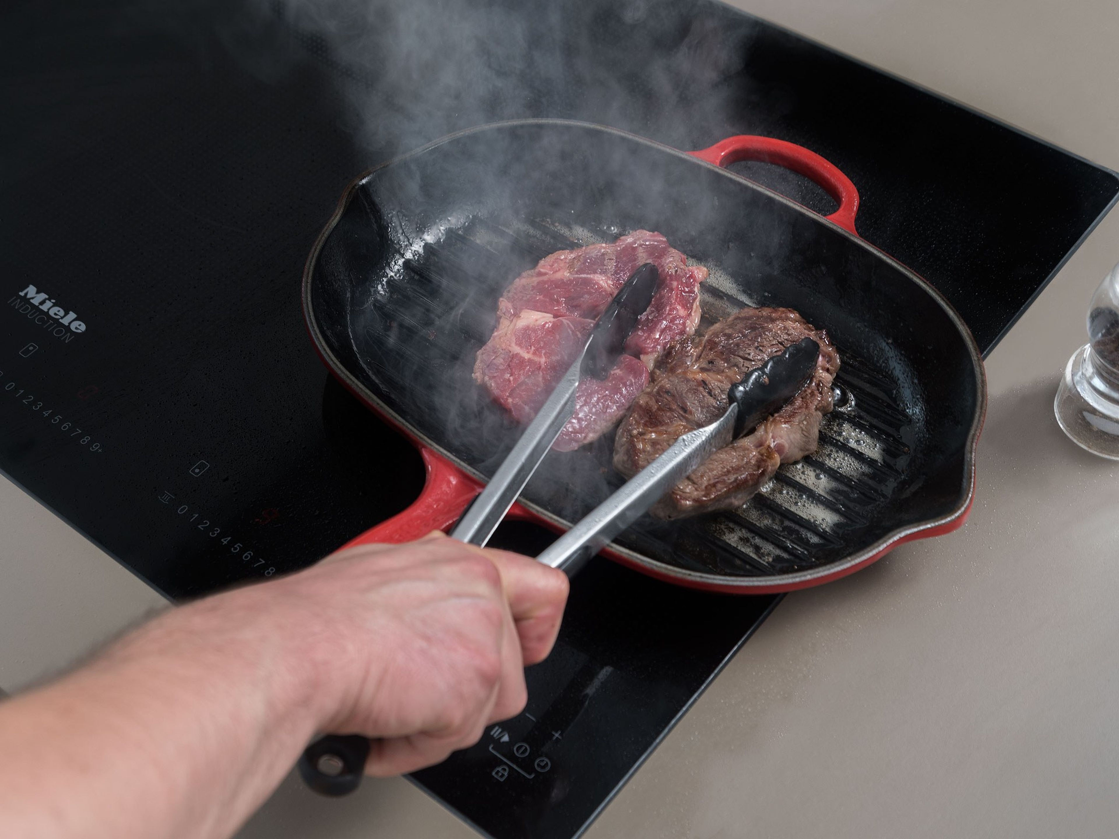 Reduce oven temperature to 160°C/325°F. Heat oil in a grill pan set over medium-high heat. Salt steaks and transfer to grill pan. Sear on both sides for approx. 3 – 4 min. When browned, transfer to a baking sheet and bake in the oven for approx. 4 min.