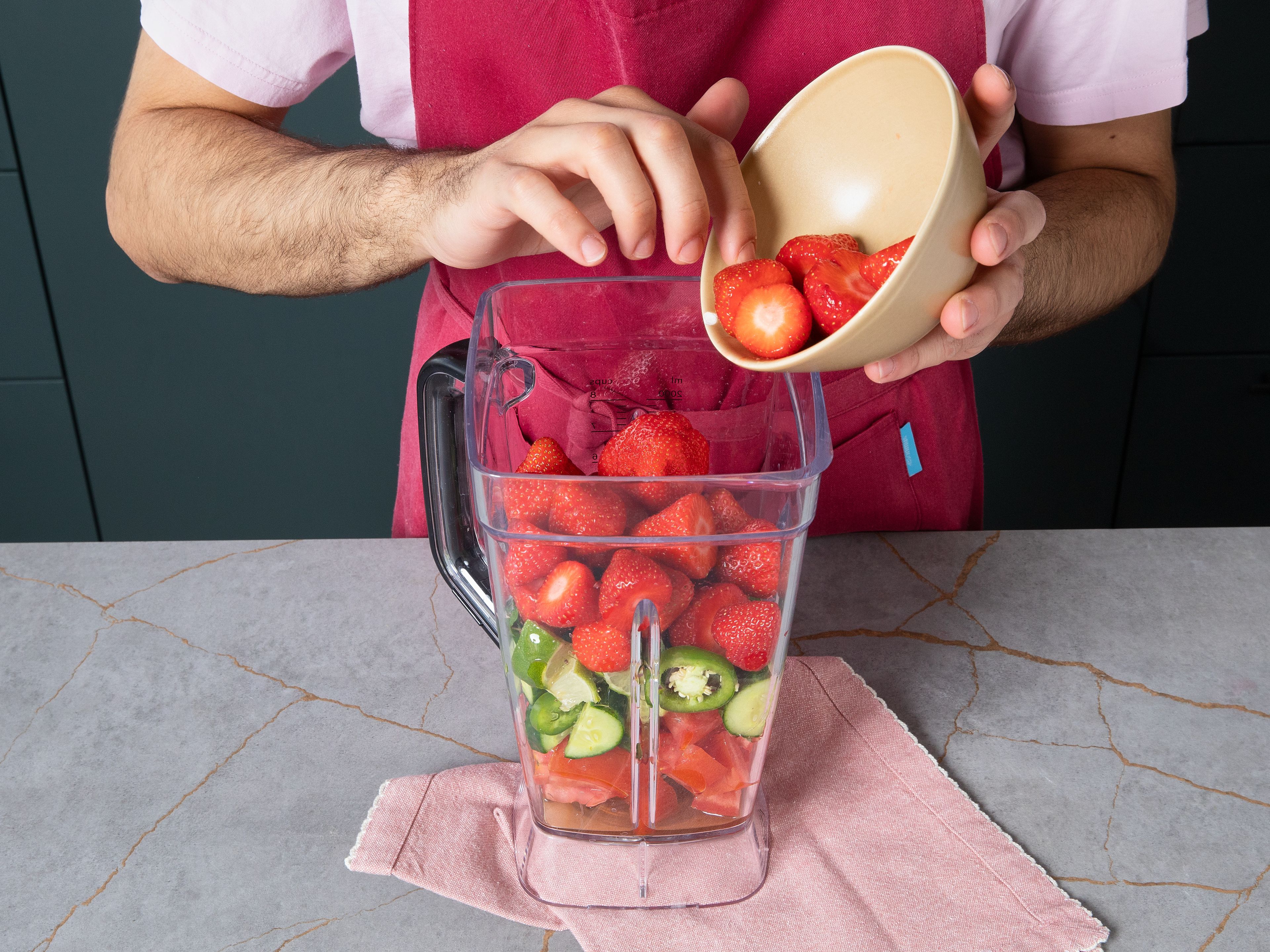 Add strawberries, tomatoes, cucumber, jalapeños, lime, mint, sherry vinegar, and honey into a blender. Add salt and pepper to taste. Blend until smooth. Transfer soup to the fridge to cool for approx. 1 hr. for the flavors to combine.