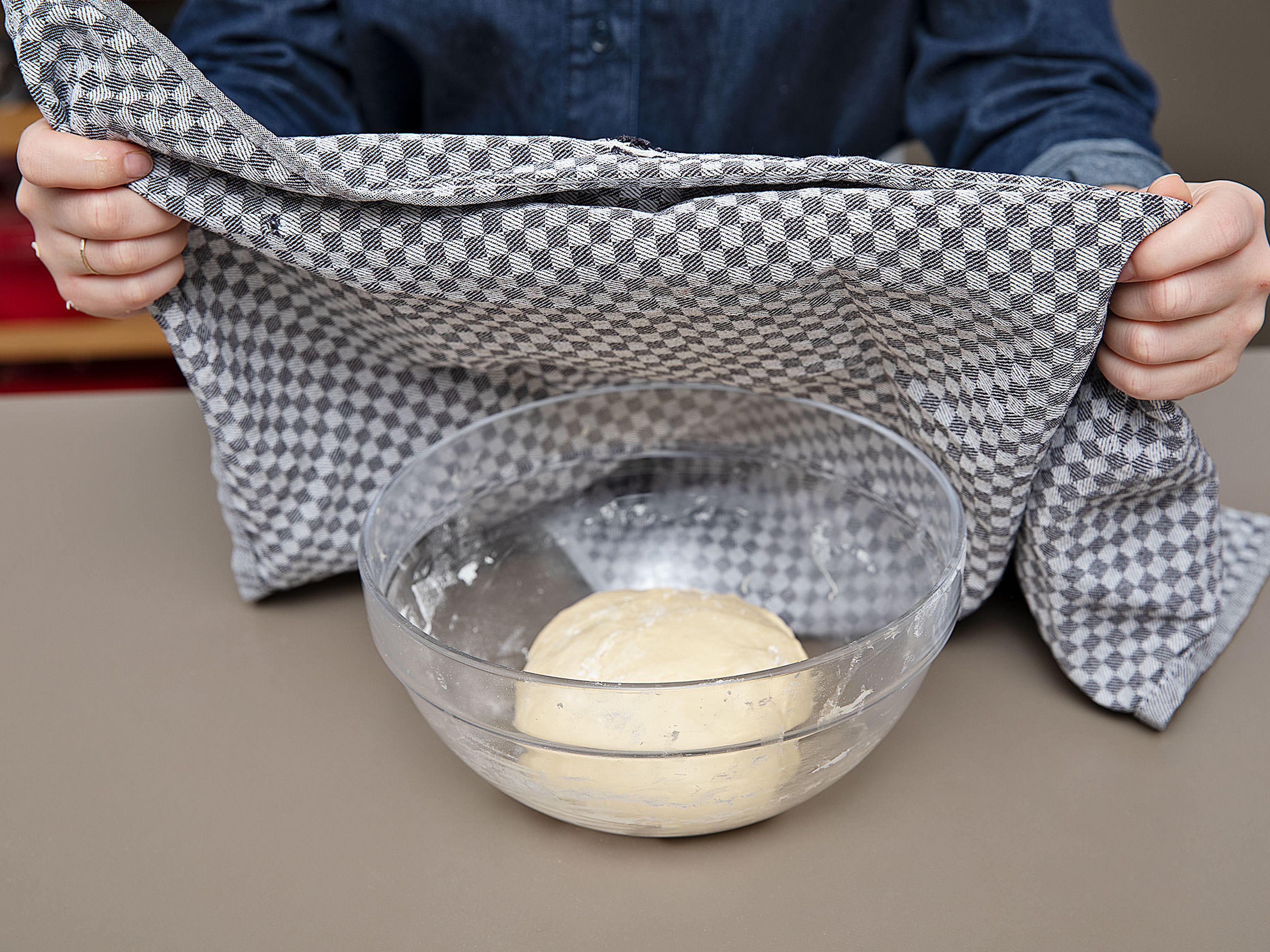 Dust the dough ball with flour and cover the bowl with a kitchen towel. Leave in a warm place to rise for approx. 2 – 4 hrs., the longer the better as it will develop flavour and the fluffiest texture.