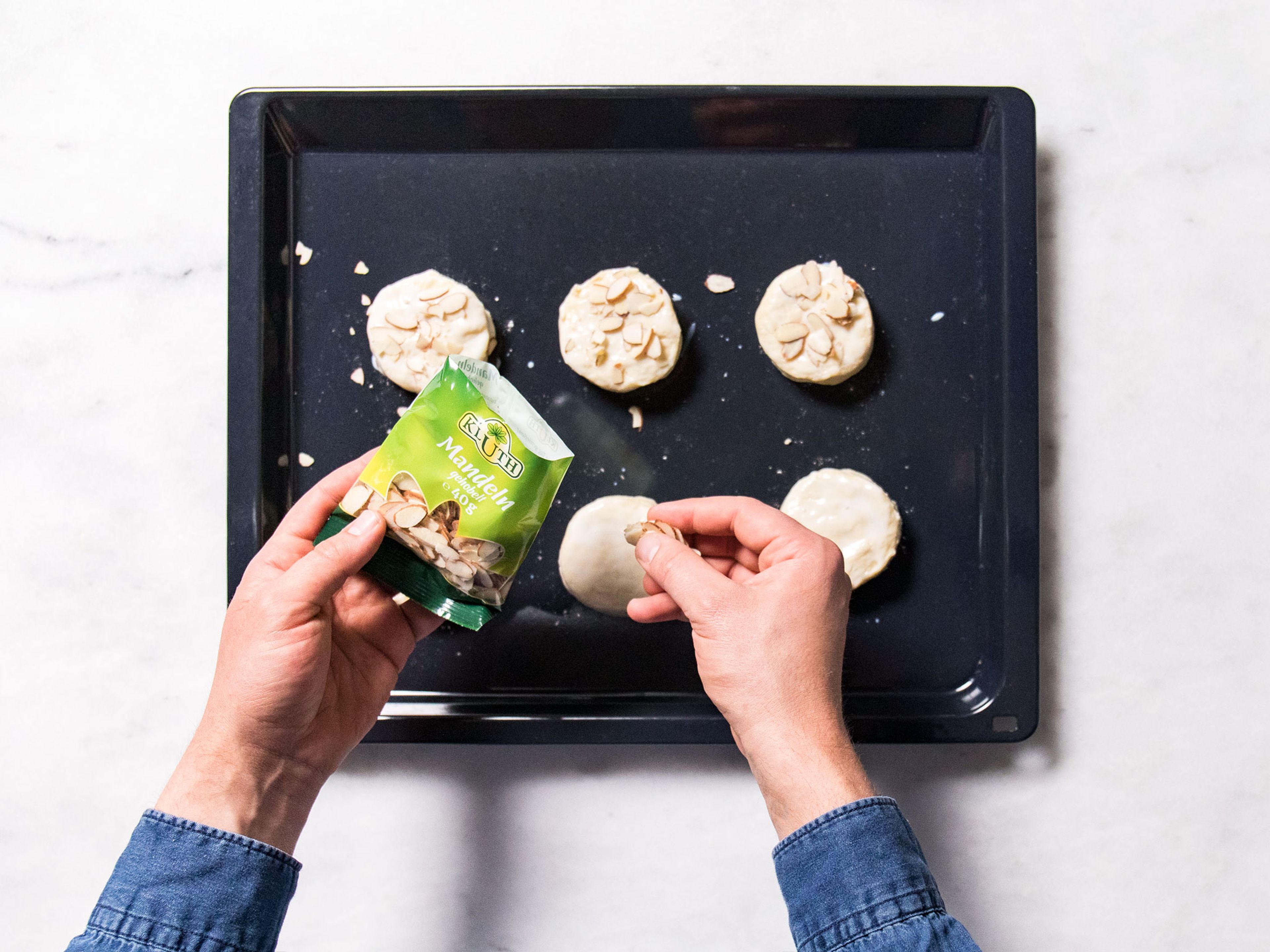 Roll out the dough with the rolling pin to a thickness of 2.5 - 3cm. Cut out the biscuits and transfer them to a baking sheet. Brush biscuits with some buttermilk, sprinkle with almonds, and bake for 15 min.