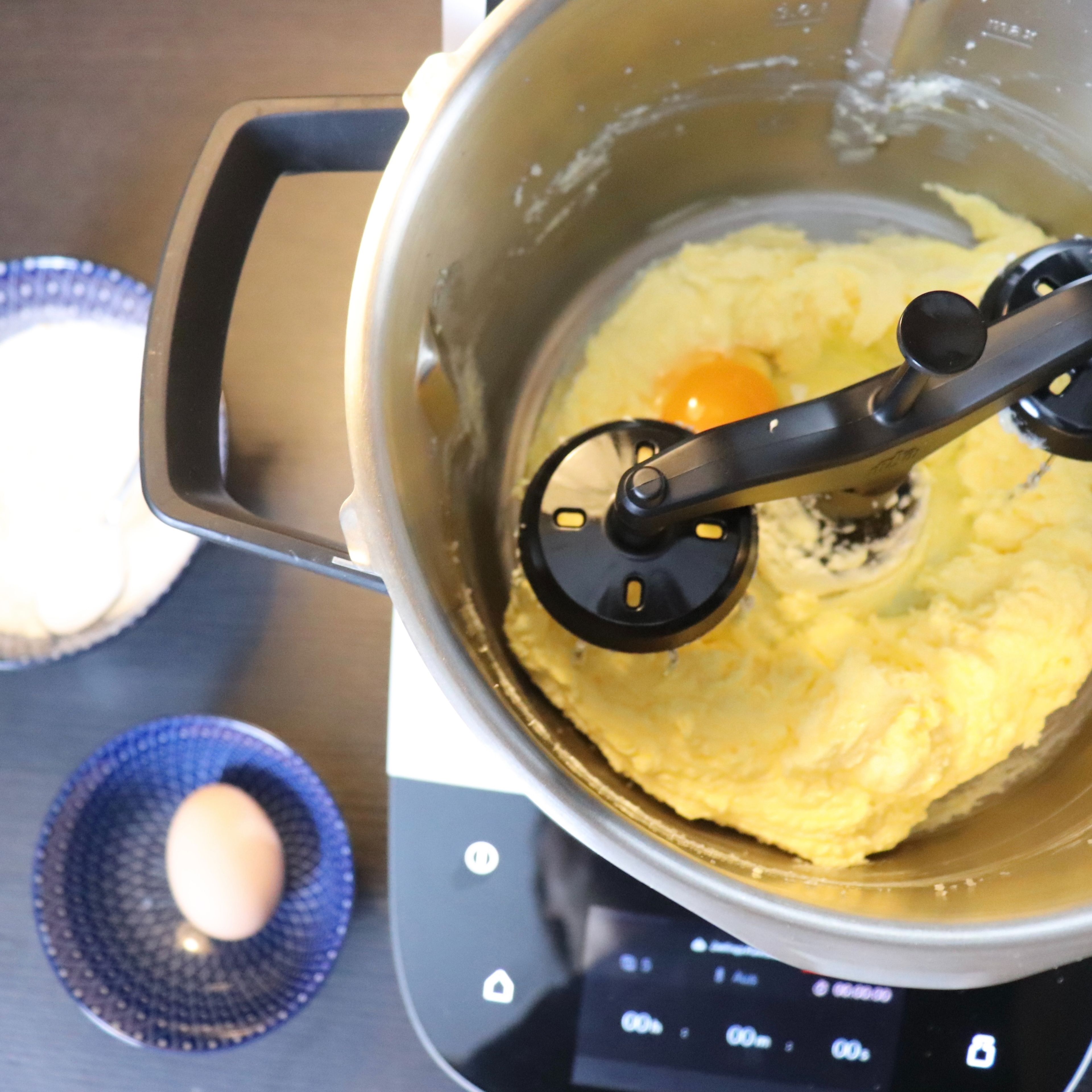 Nun können die Eier einzeln untergerührt werden (Zwillings-Rührbesen | Stufe 5 | 30 sec). Nach dem zweiten Ei einmal den Topfrand abschaben. Beim letzten Ei wird die Masse für 1 min geschlagen.
