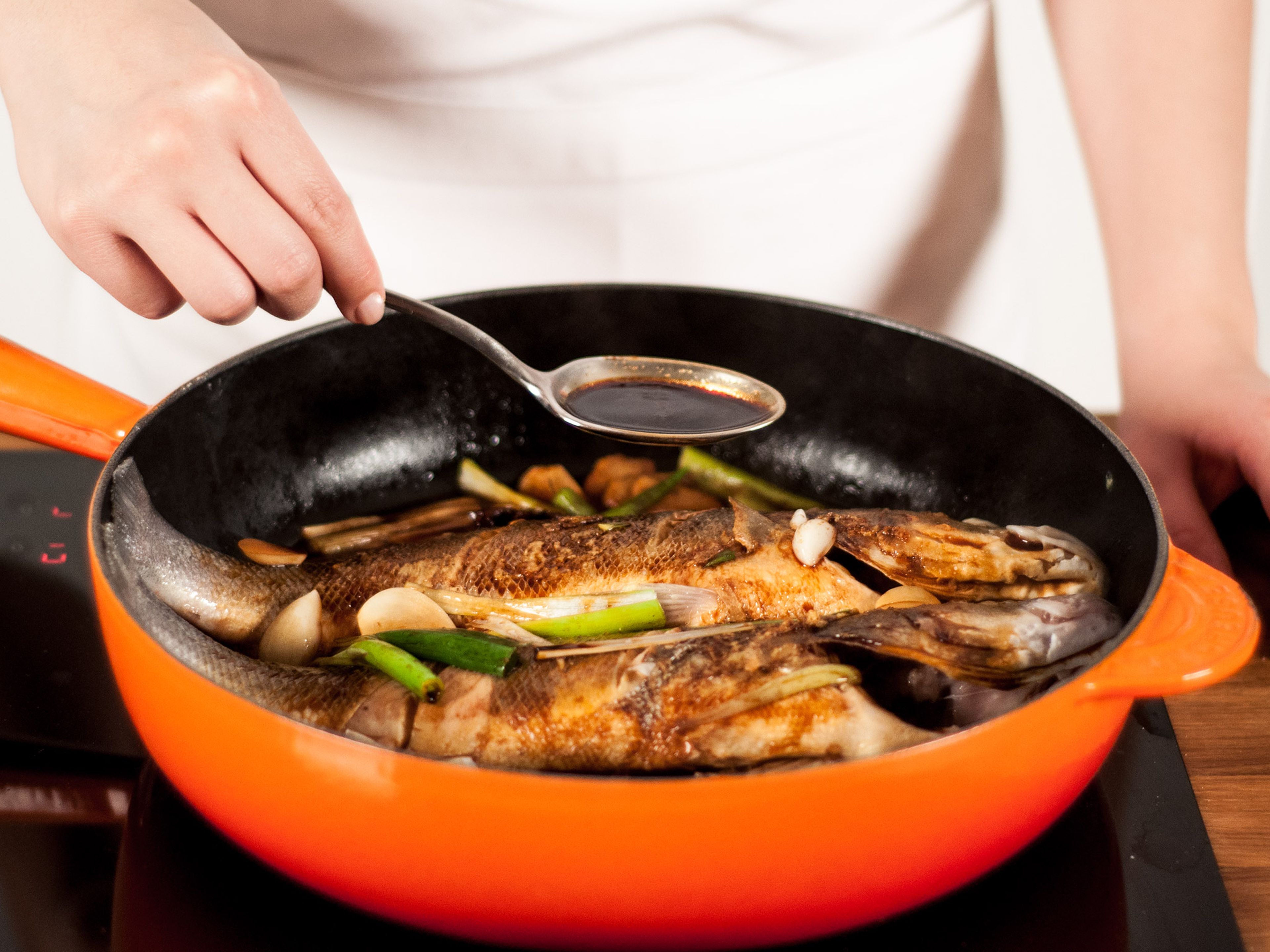 Add water to the pan. Using a spoon, cover the fish with sauce. Cover pan with a lid and allow to simmer on medium-low heat for approx. 20 – 23 min.