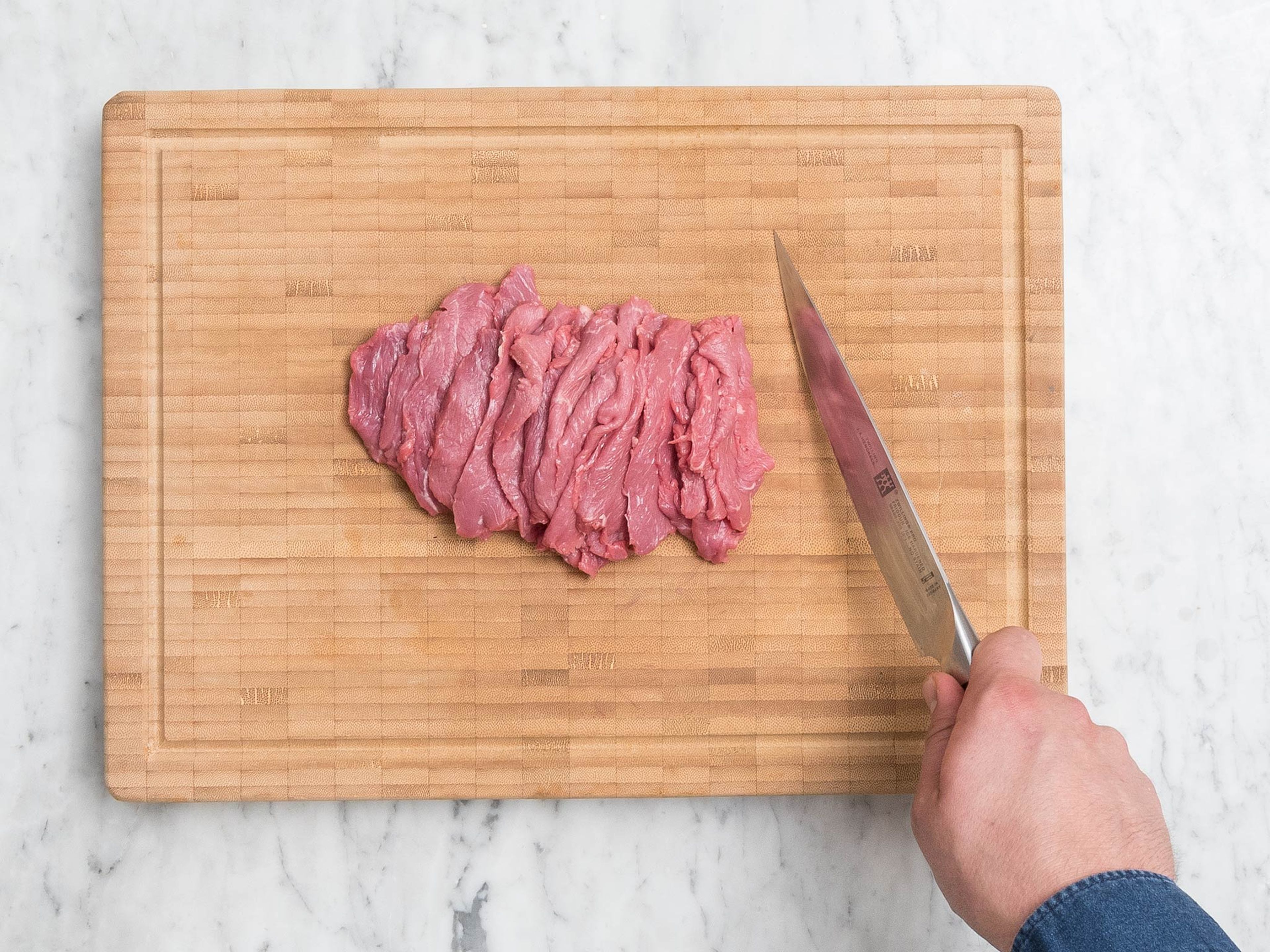 Trim extra fat from beef sirloin, pat dry with paper towels, and cut into strips.