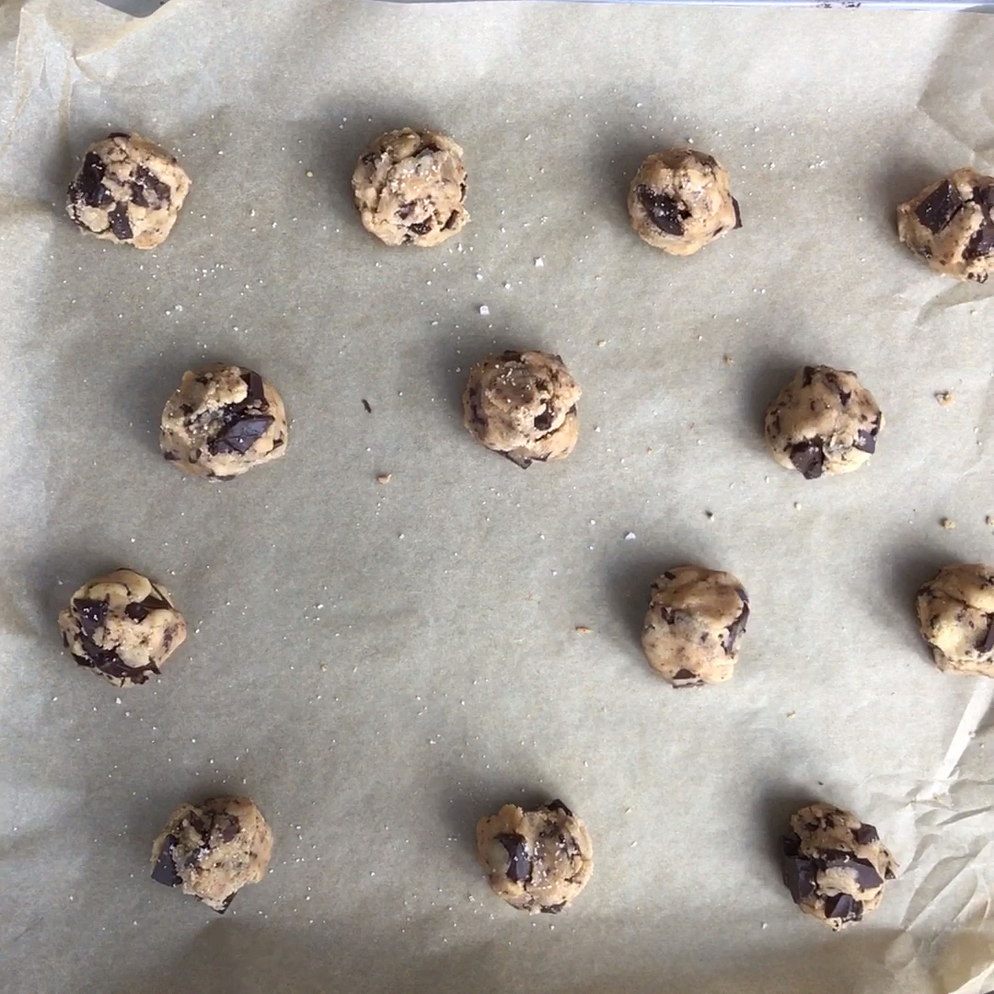 Use an ice cream scoop or a large spoon to form equal-sized cookies. Transfer to a parchment-lined baking sheet, leaving plenty of room in between as they will spread out while they bake.