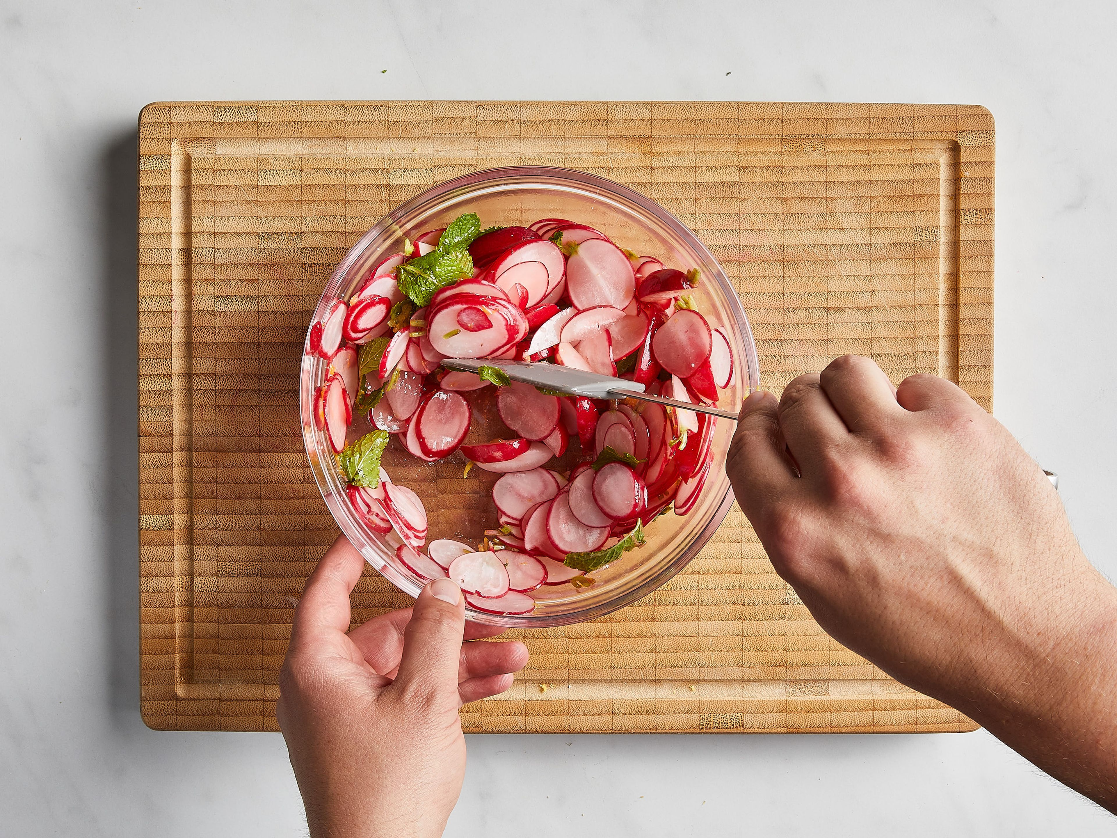 Transfer all the radishes to a large bowl. Season with salt and add half the lemon juice and zest, tossing to combine and massaging the radishes gently with your hands. Add melted butter, toss again, and taste. Add more lemon zest and juice to taste.