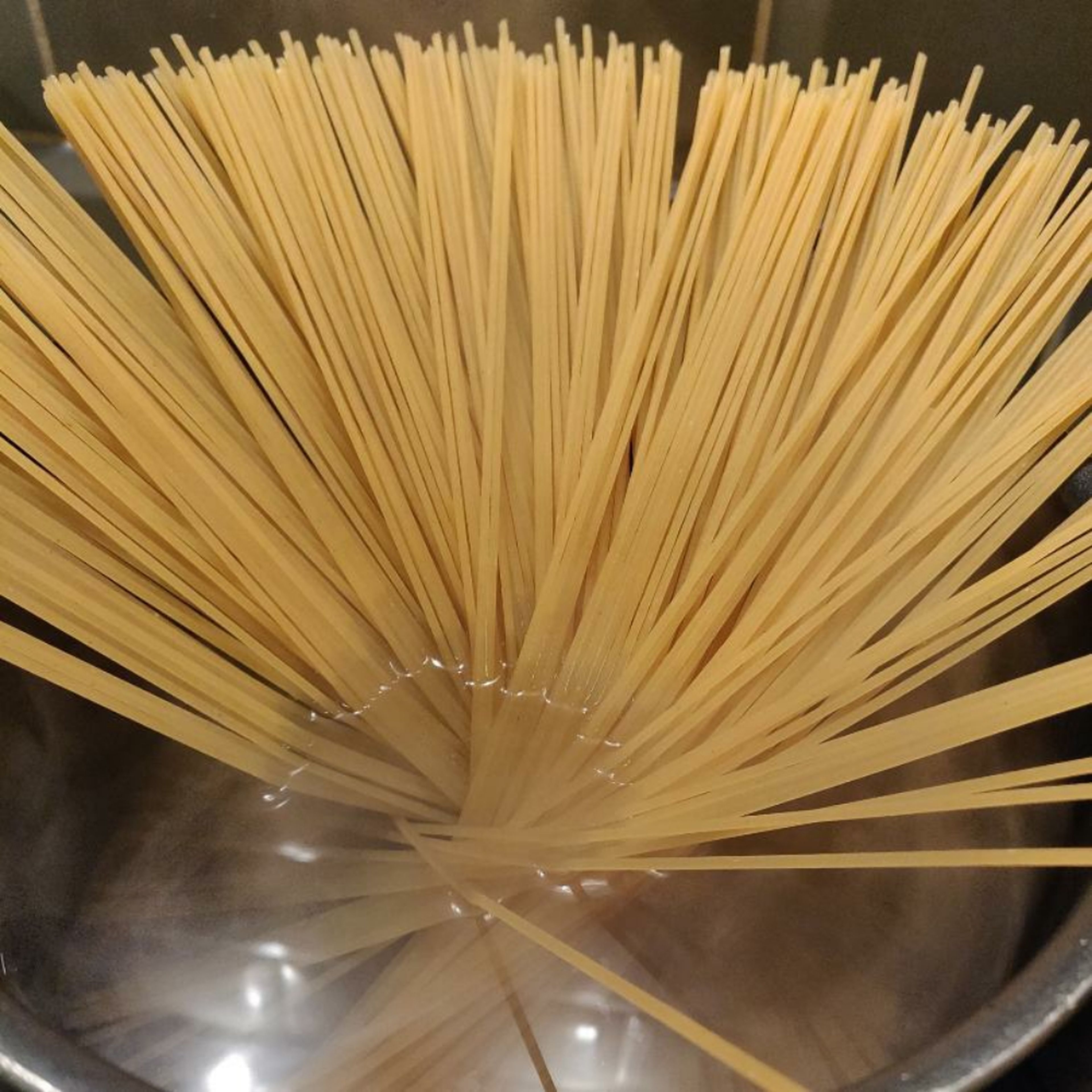 In a pot, boil a good amount of water + generous amount of salt and cook your spaghetti until al dente.