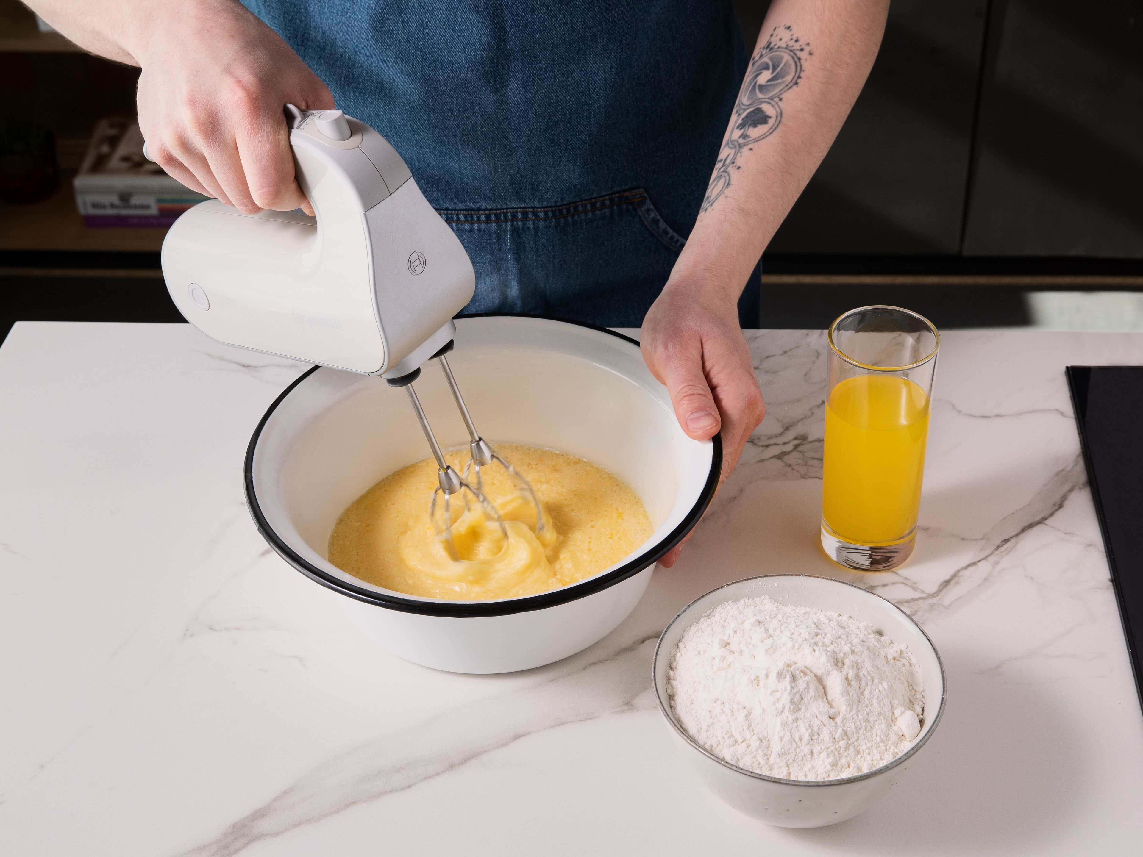 To make the cake: Preheat the oven to 180°C (160°C fan). Cream butter, sugar, and eggs in a large bowl. Mix flour, baking powder, and a pinch of salt separately, then add to the wet ingredients. Finally, stir in the orange soda until smooth. Spread the batter onto a lined deep baking tray and bake for approx. 25 min. Let cool completely.