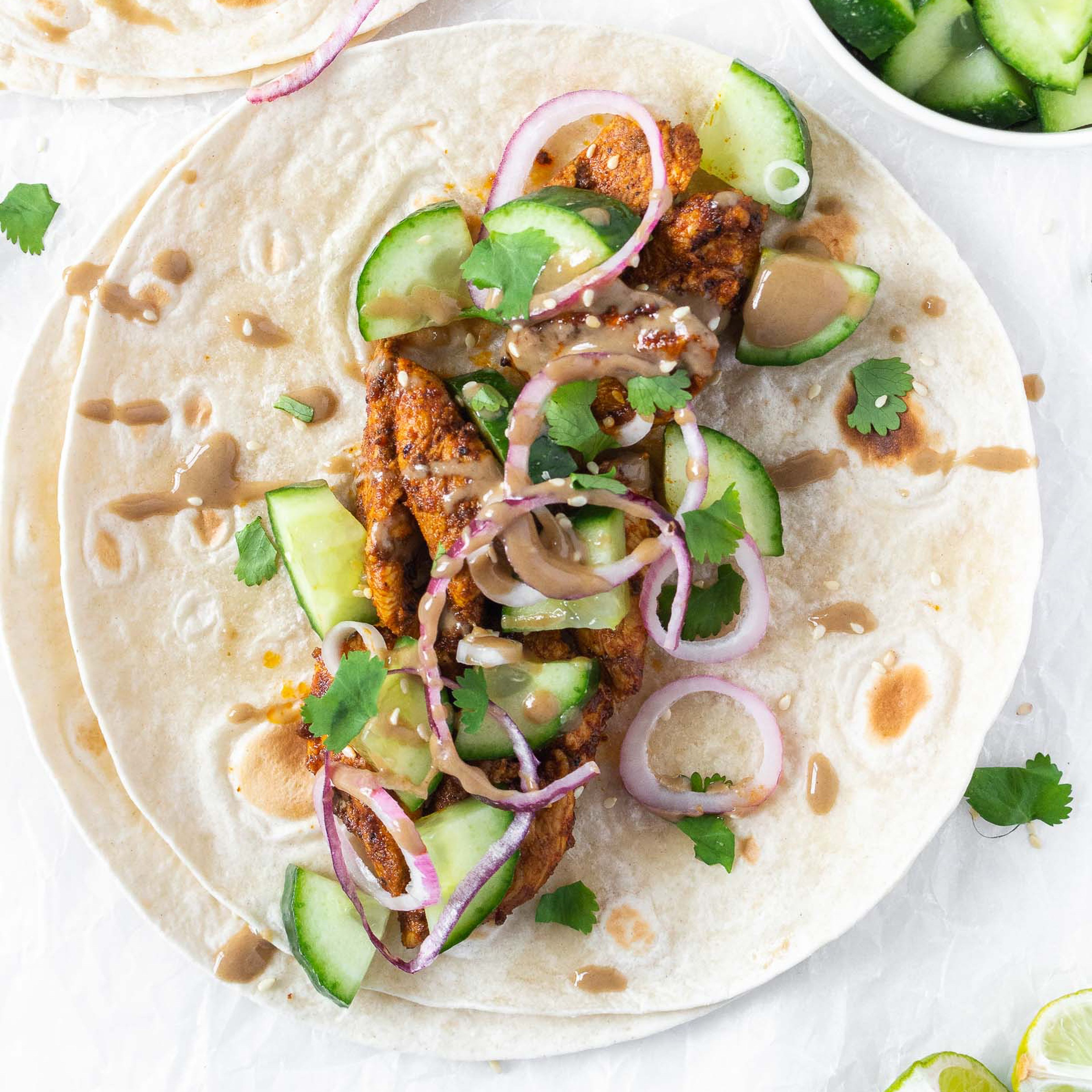 Assemble tortilla wraps with chicken and toppings, roll up and enjoy!
