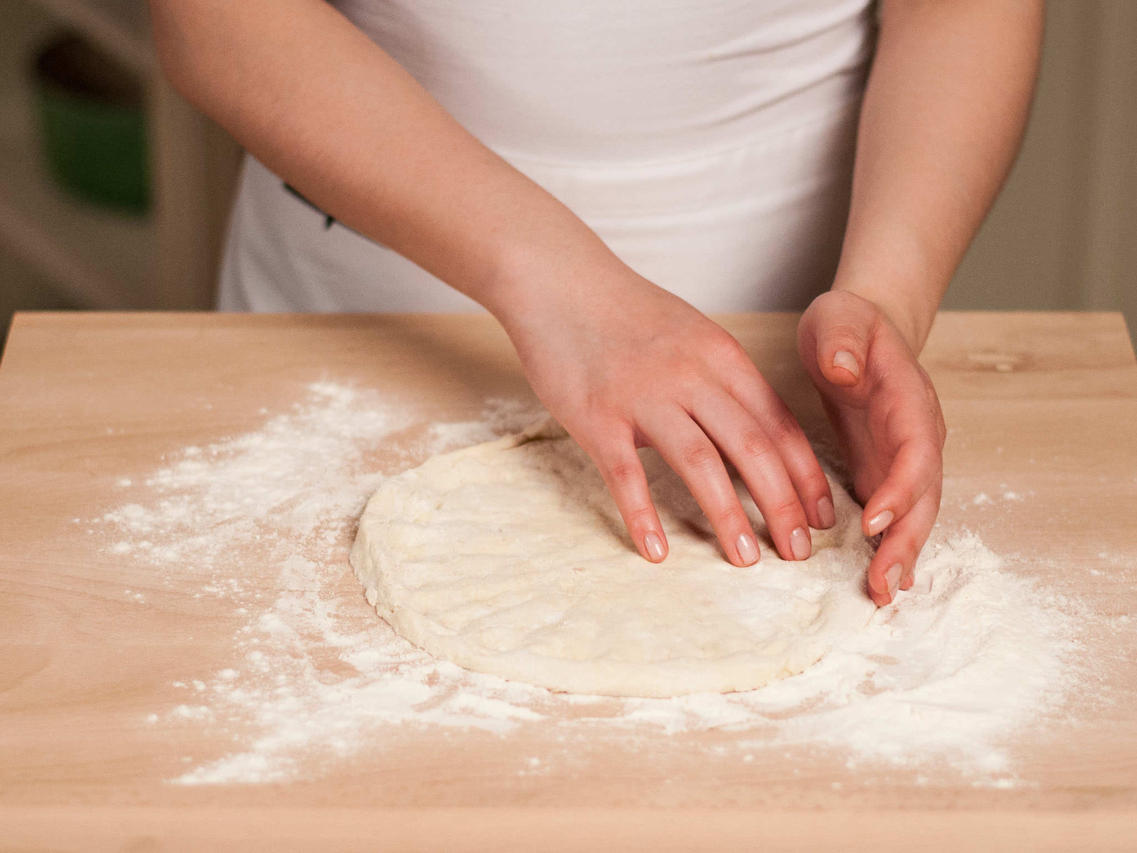 Divide dough into four equal parts. Form each part into a flat circle approx. 1 cm thick. If desired, form a thin border.
