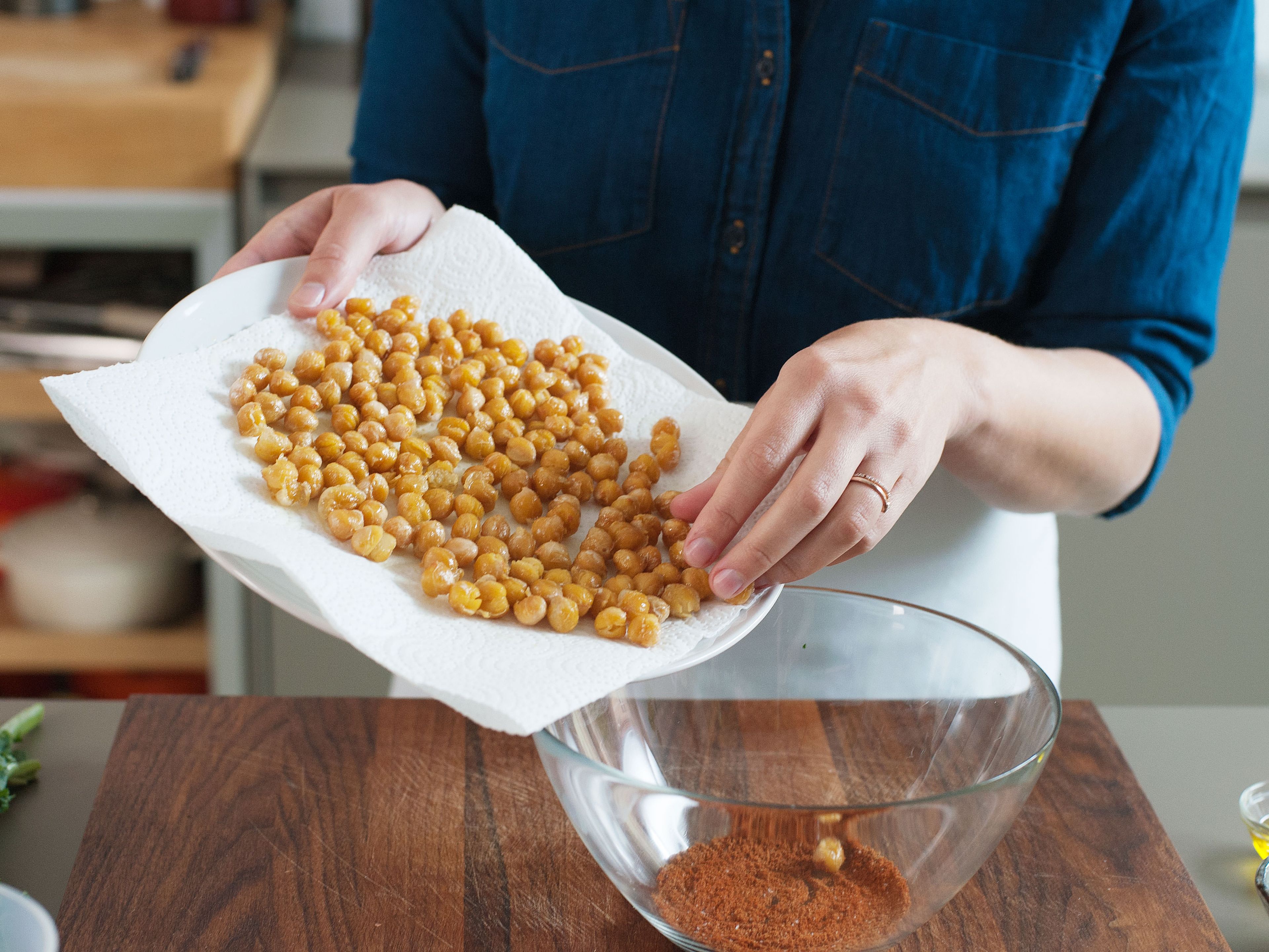Combine paprika powder, cayenne, coriander, and salt in a mixing bowl. Add fried chickpeas and toss to combine. Season with salt and pepper. Set aside.
