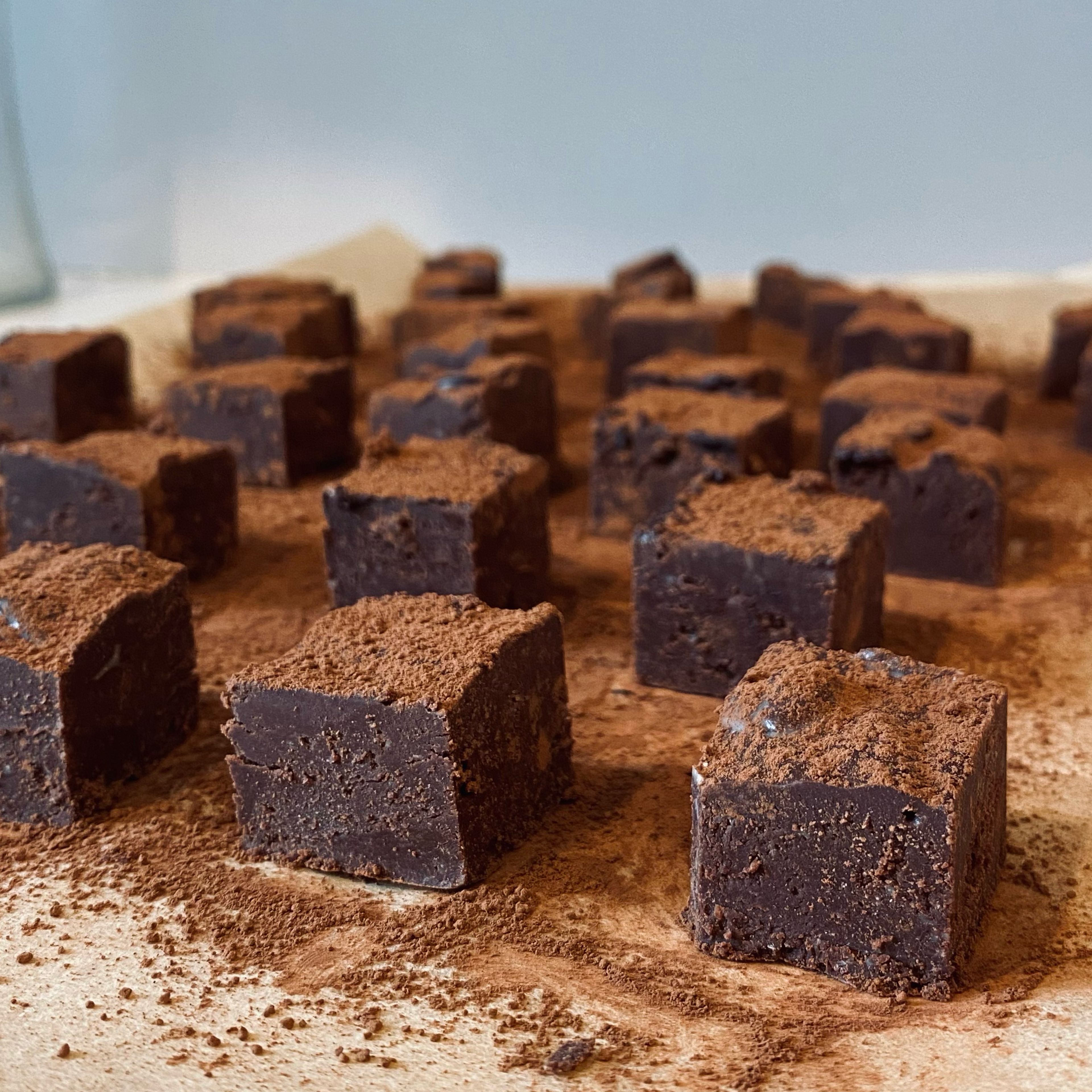 Once removed from tin, cut them into squares. Dust with cocoa powder.