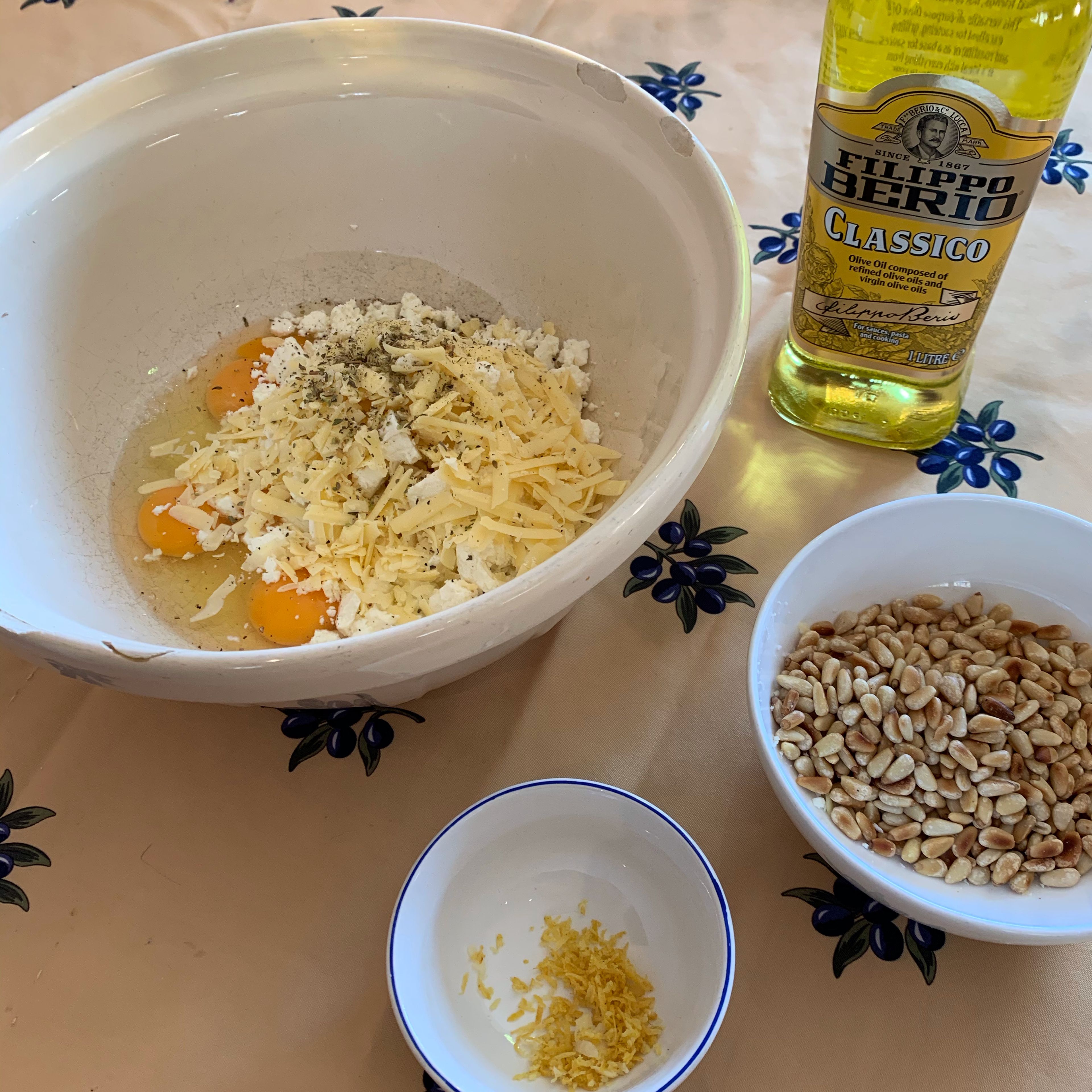 Zest 1 lemon and add it to the mixing bowl with the toasted pine nuts and a drizzle of olive oil