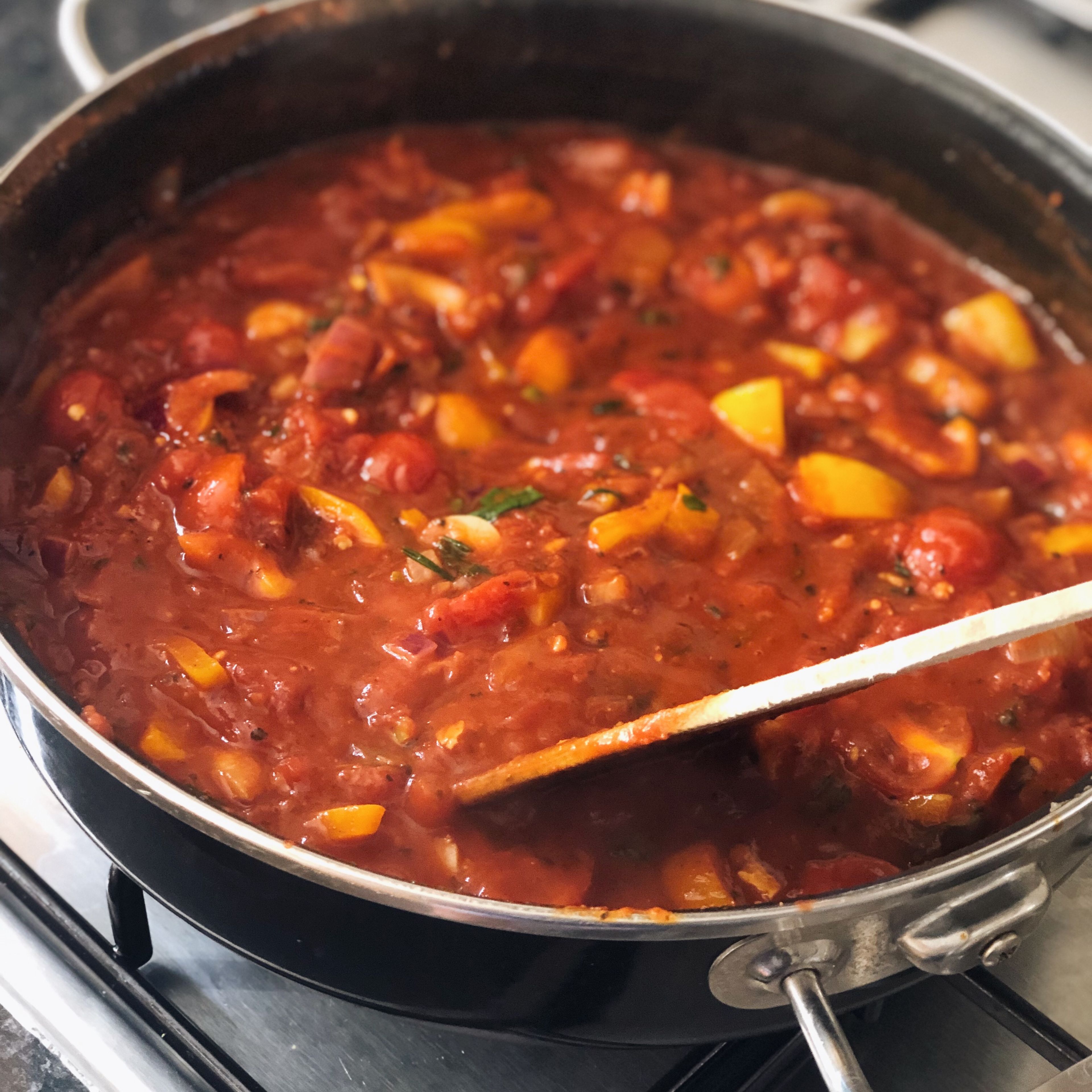 Pour in tinned chopped tomatoes. Add splash of water to each empty tin and pour in the pan. Add soy sauce, worcestershire sauce (I use Biona Organic vegan Worcestershire), lemon sugar and sriracha sauce. Simmer with lid on for 10 minutes.