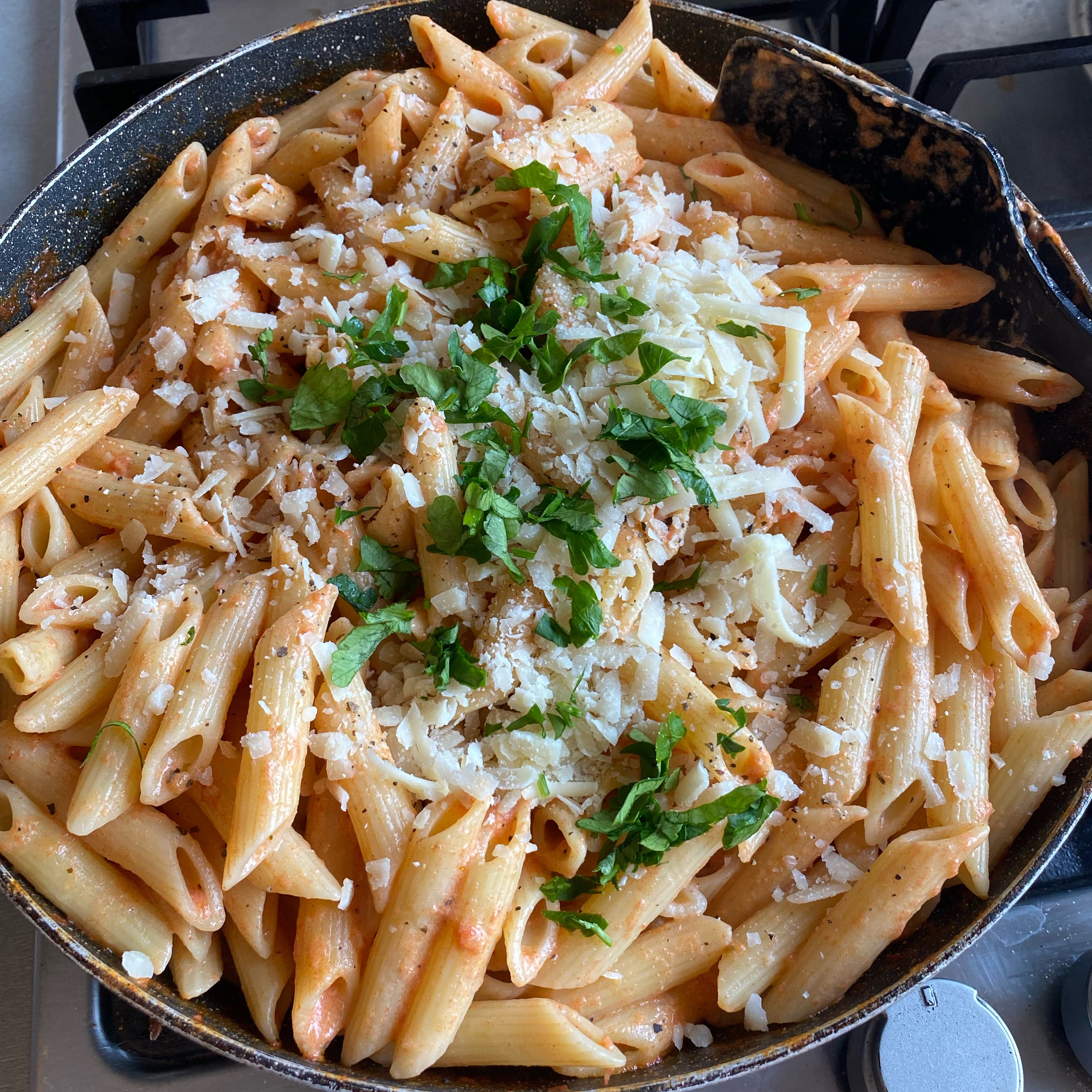 Add the drained pasta, water from pasta, more salt and pepper, Parmesan Cheese and fresh chopped parsley.