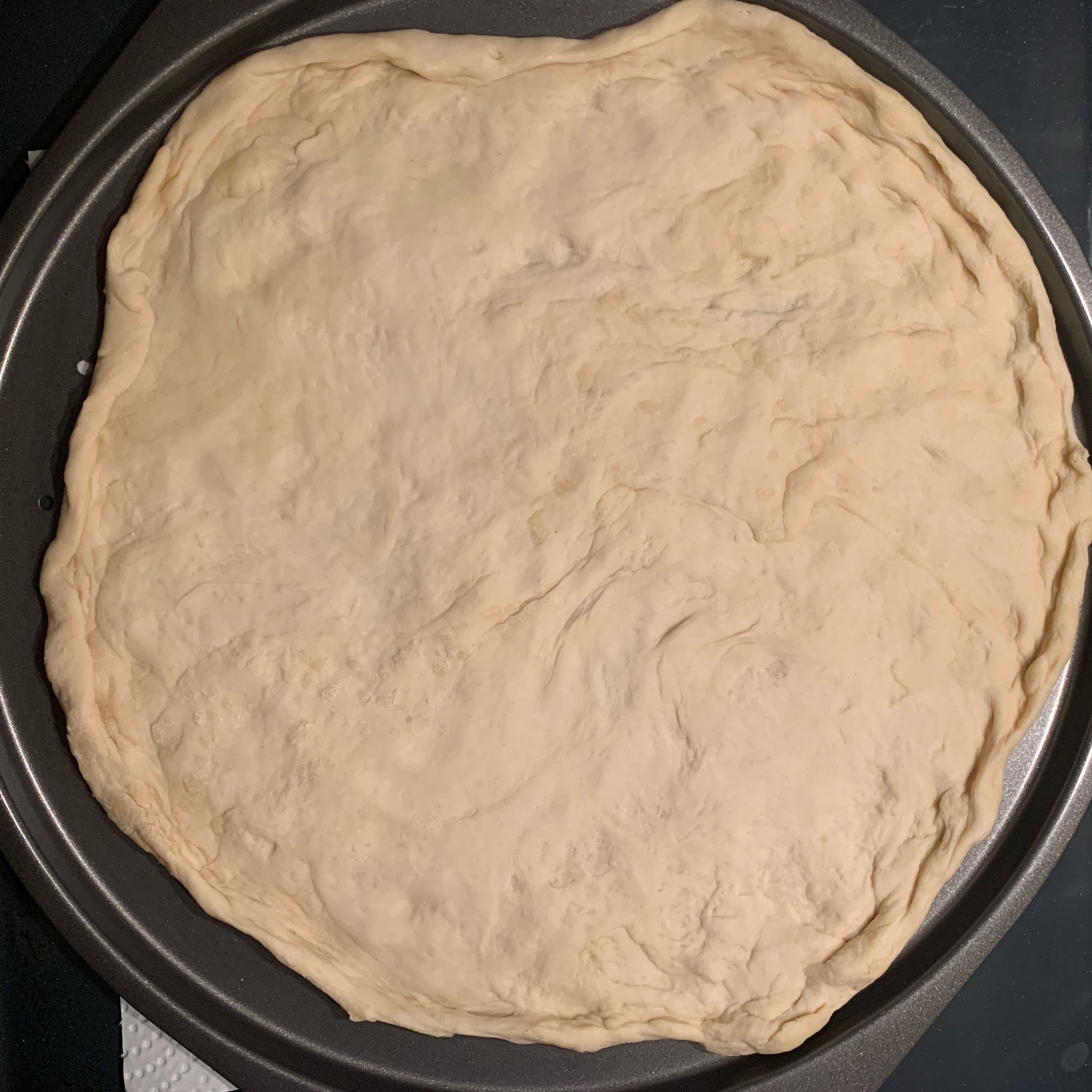 Roll out the dough on an oiled baking dish or pizza tray. (Here I have used half of the dough to make two separate pizze). 