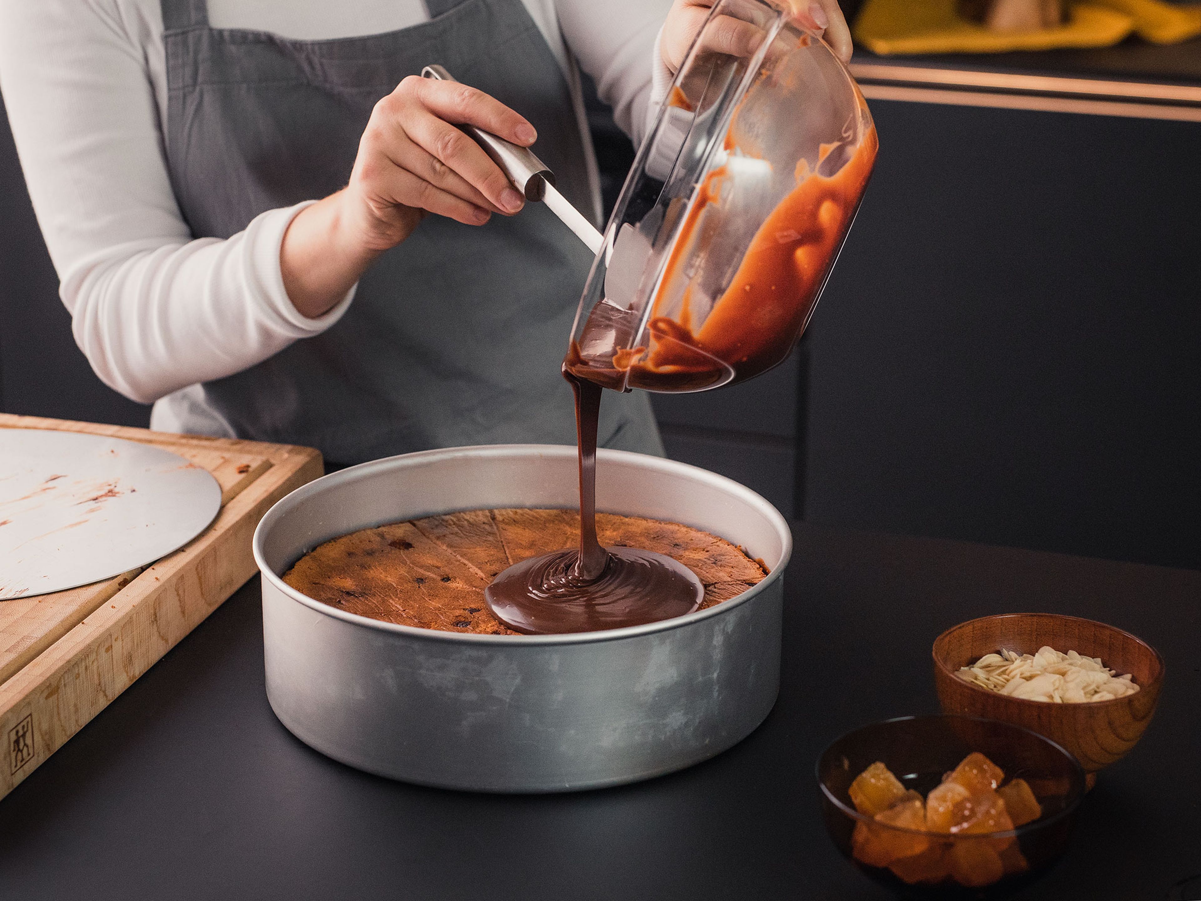 Remove the cooled pumpkin cake from the springform pan with a small knife. Use a serrated knife to halve the cake horizontally. Add one cake half back to the springform pan and drizzle with orange juice.
