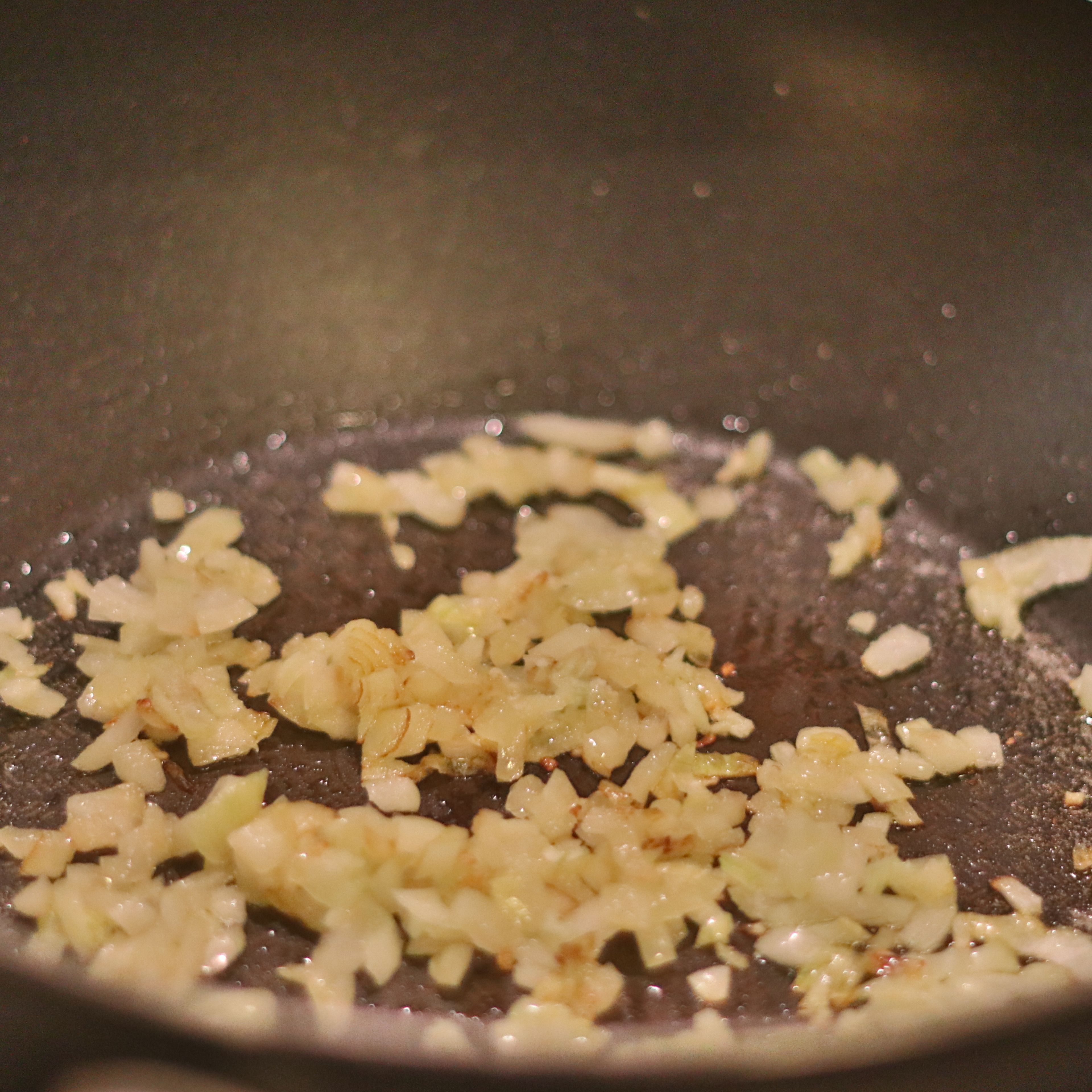 Add onion and garlic to a frying pan with some olive oil and let cook on medium heat until soft, approx 5 minutes.