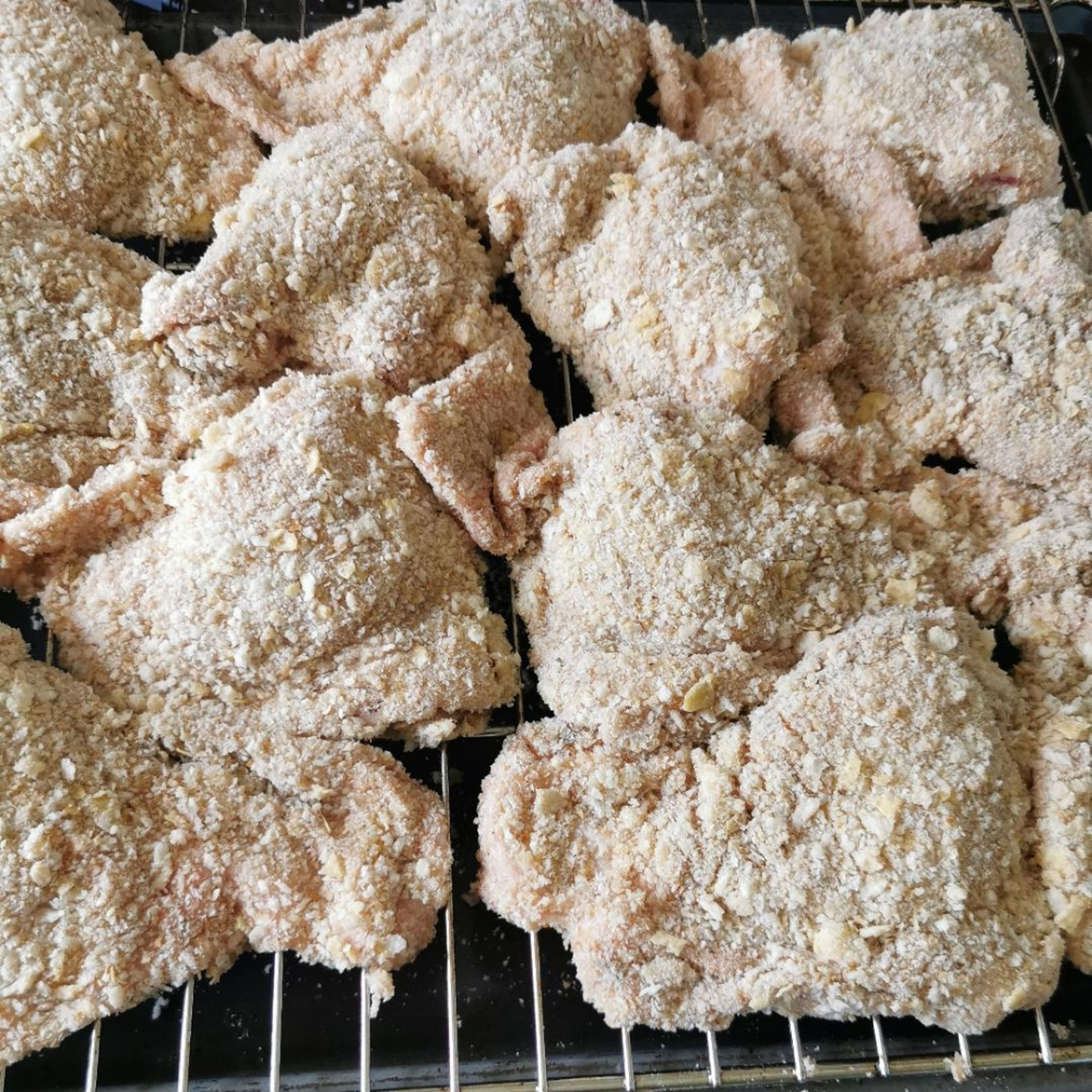 Once all you portions are crumbed, place on a wire rack. Drizzle with oil or spray you won't need to much as the fat in the skin will help to crisp the coating. I placed a bit of sweet potato under the chicken to roast, saving time.