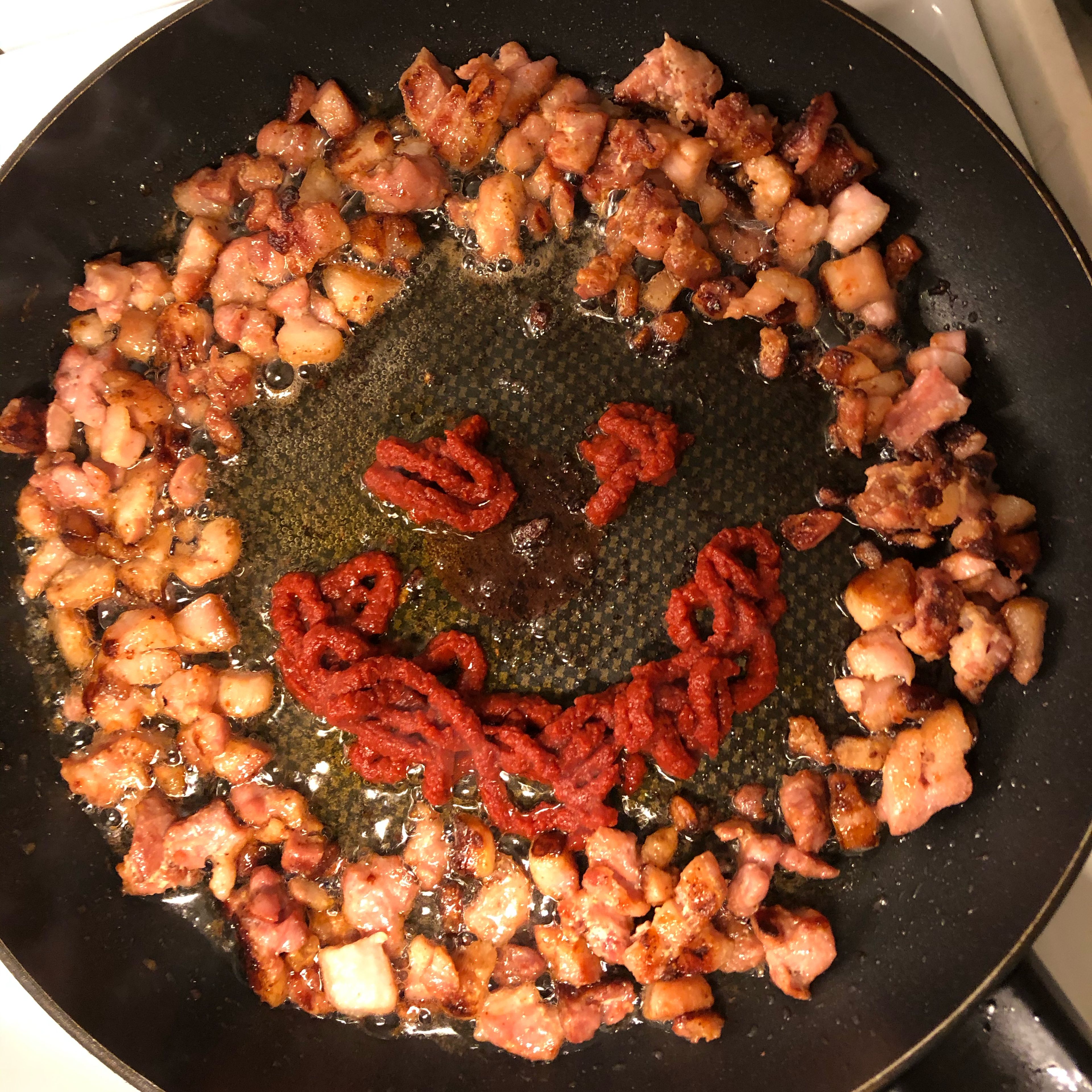 Fry bacon and add tomatoe purée