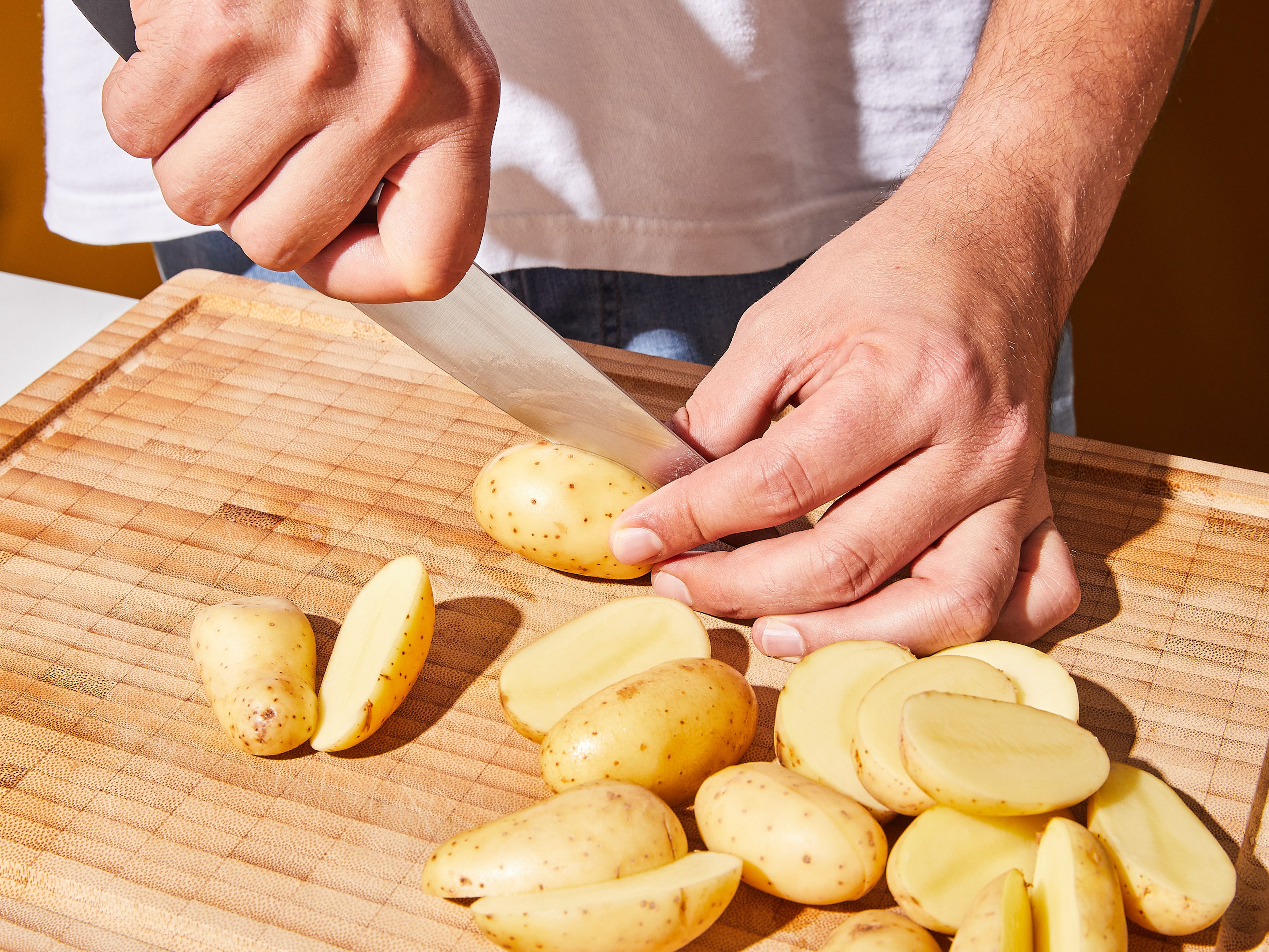 Halve potatoes or quarter them, if using bigger ones. Transfer potatoes to a large pot of salted room temperature water and bring to a boil. Once boiling, lower the heat and let simmer for approx. 10 min., or until tender. Once they are done, drain potatoes and leave in the pan to finish steaming.