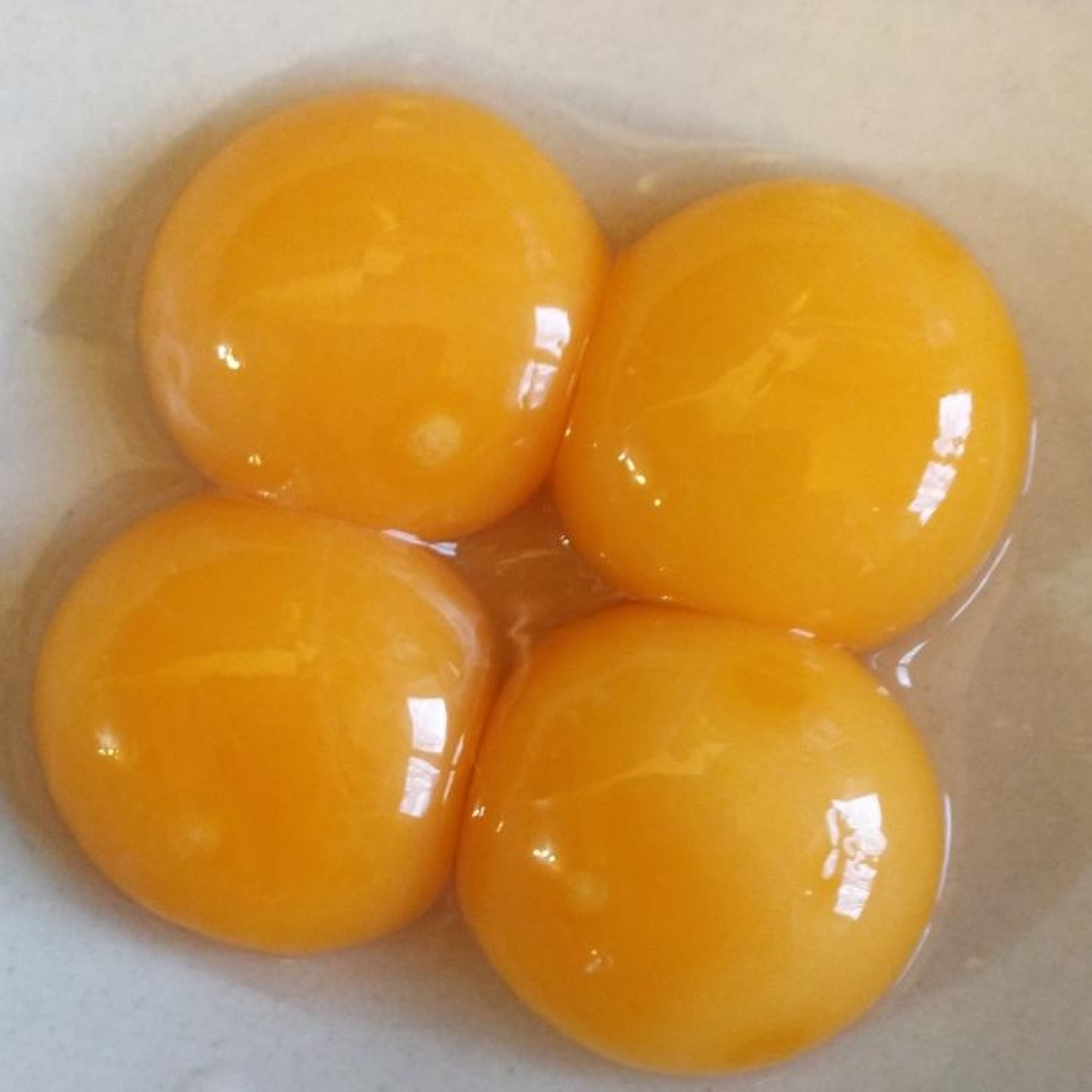 Separate the eggs, and bring a pan of water to a gentle simmer over a low heat. Slowly place the egg yolks in the water one by one, and simmer for 30-40 seconds or until the outside has solidified and the inside seems soft. Place on a plate lined with paper towels to drain off any excess liquid. Sprinkle with sea salt whilst they are still warm.