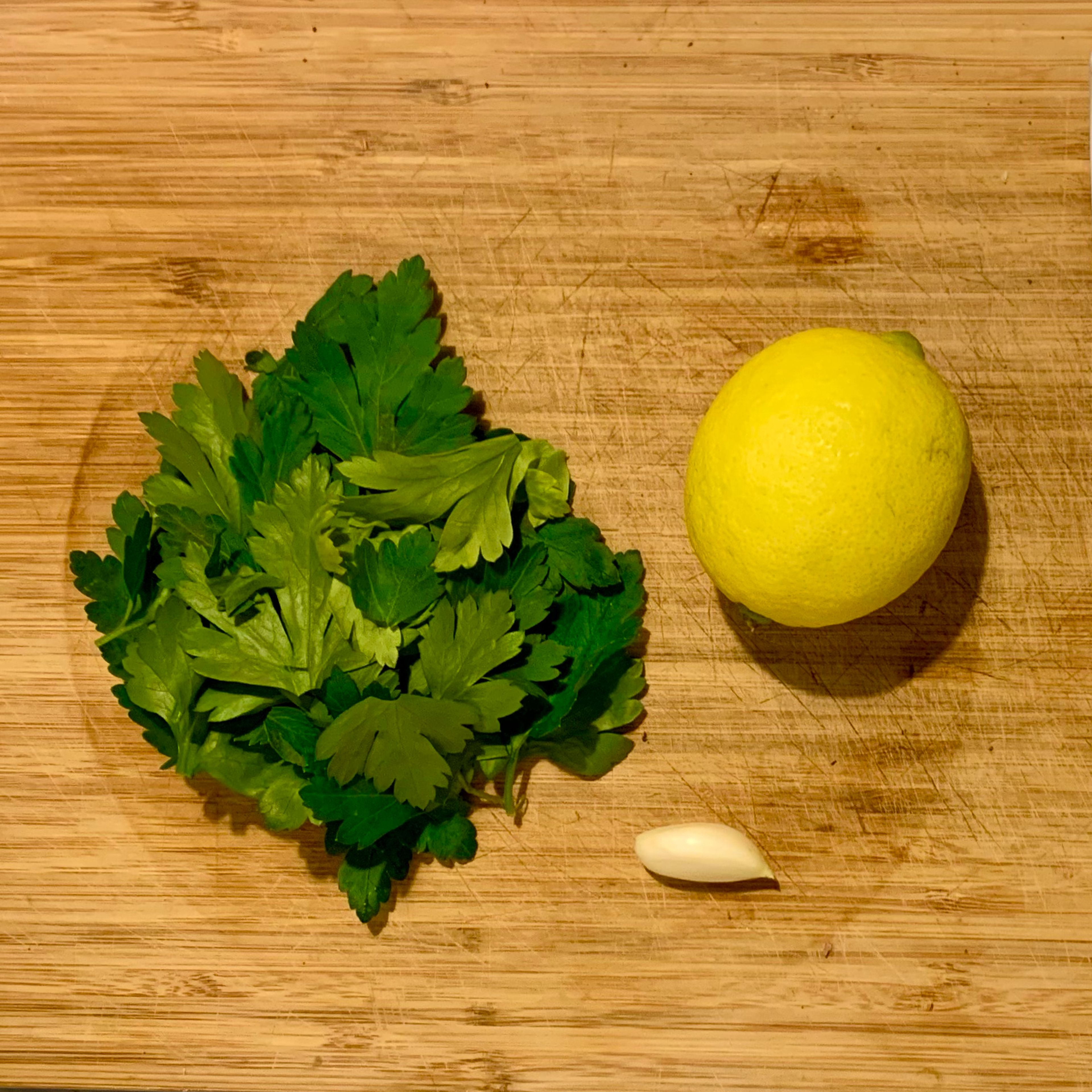 Chop the parsley, squeeze 1 lemon, and crush the garlic