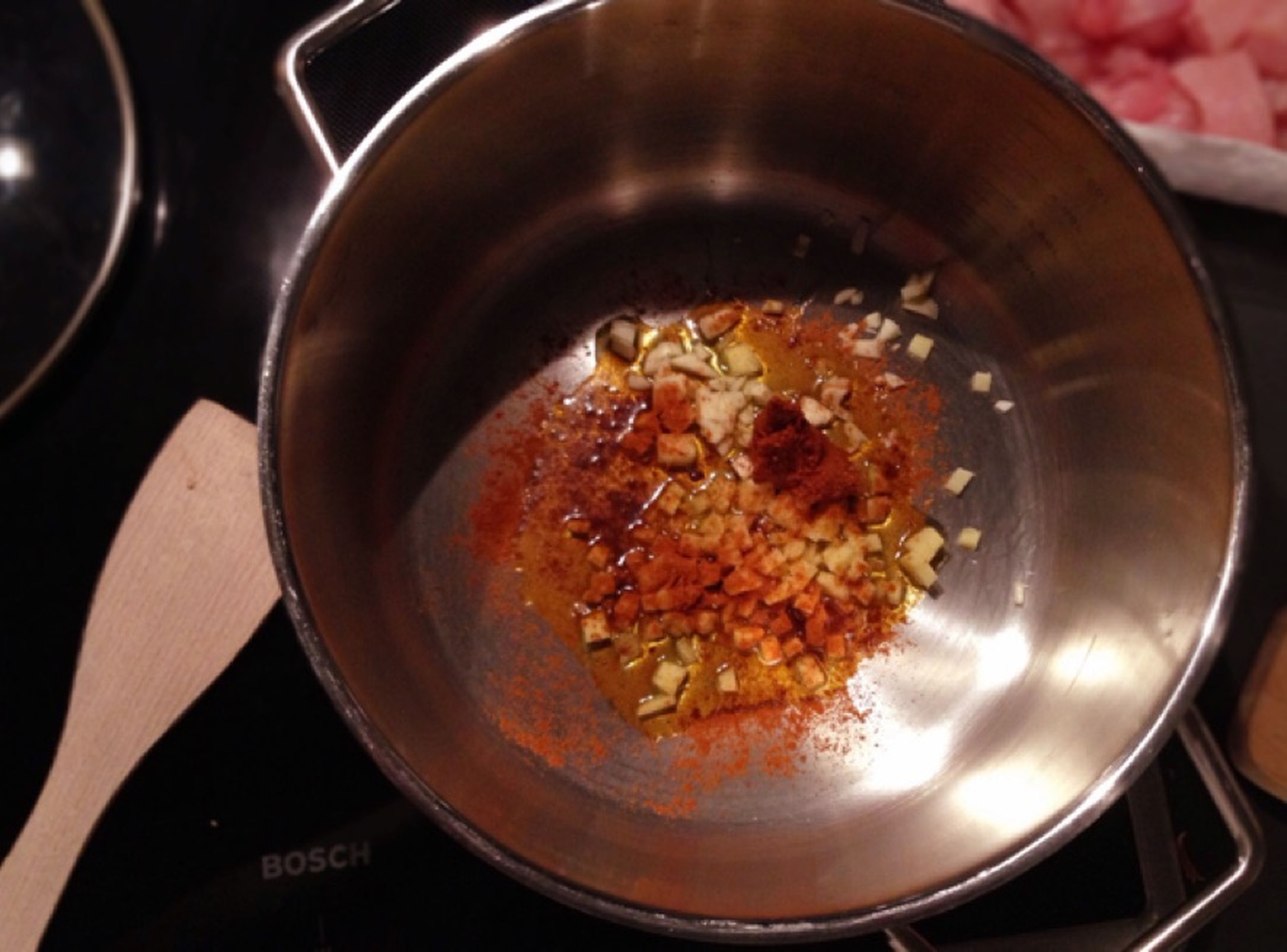Heat olive oil in a large pot. Add garlic, ginger, curry powder, chili powder, and curry paste and fry until fragrant.