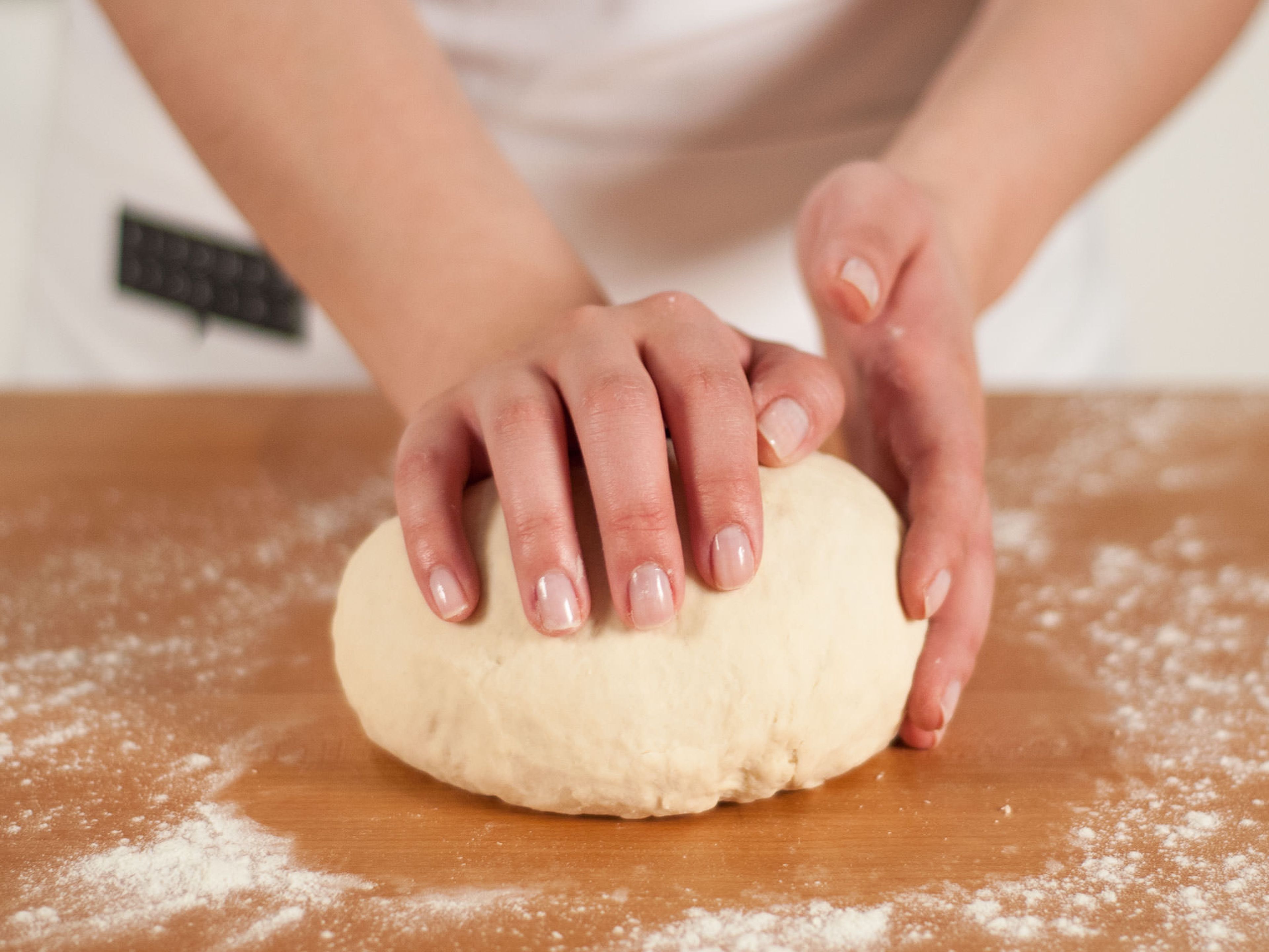 On a lightly floured surface, continue to knead dough by hand until smooth. Place into a bowl and cover with a clean kitchen towel. Set aside and allow to rest for approx. 30 – 40 min.